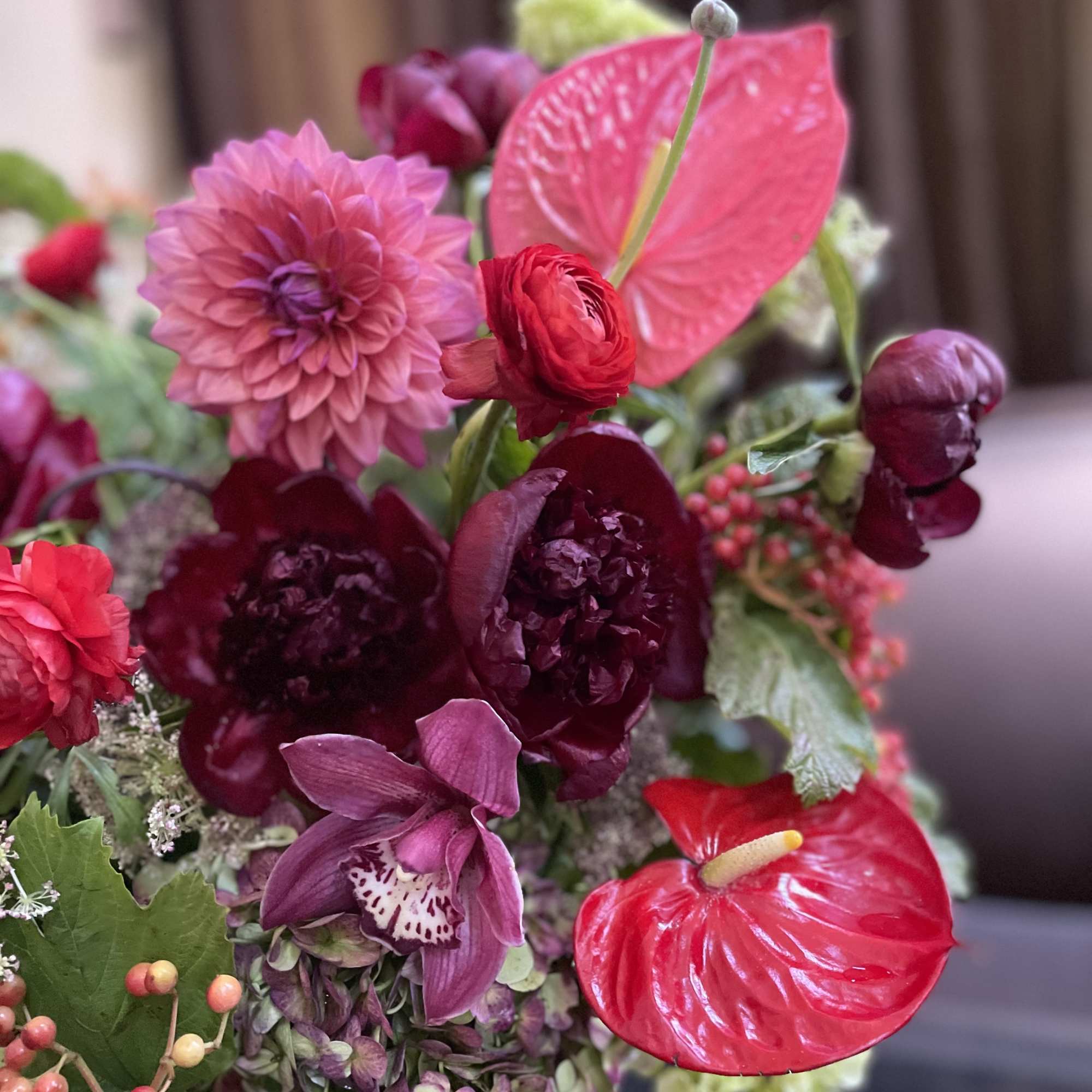 Bouquet with pink dahlias, red anthuriums, and purple orchids