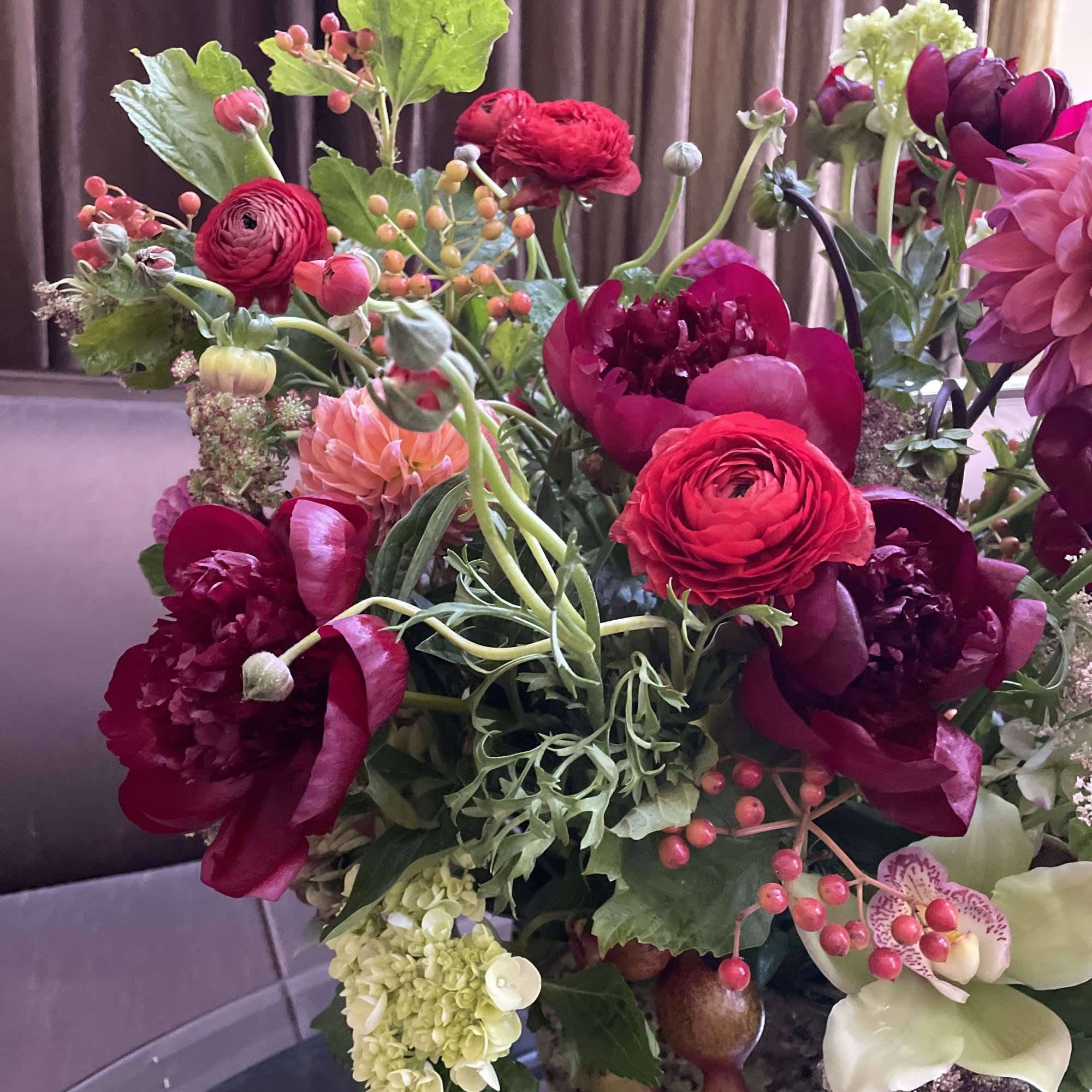 Mixed bouquet with deep red and pink flowers in a vase
