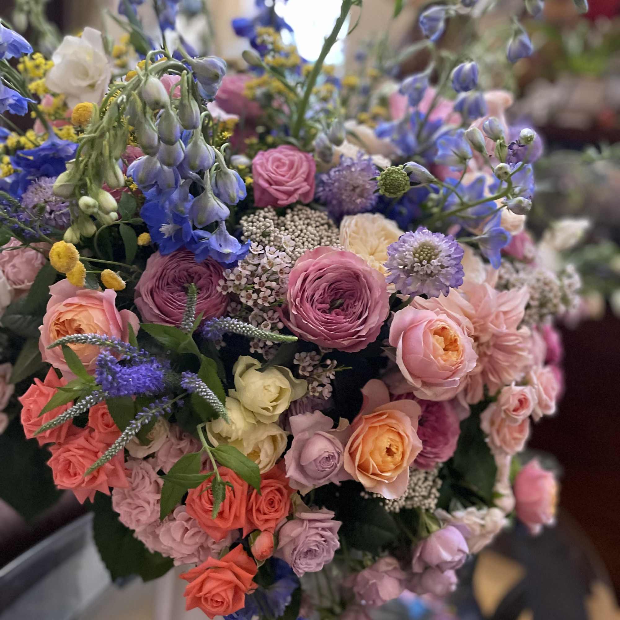 Mixed bouquet of pink, purple, blue, and peach flowers