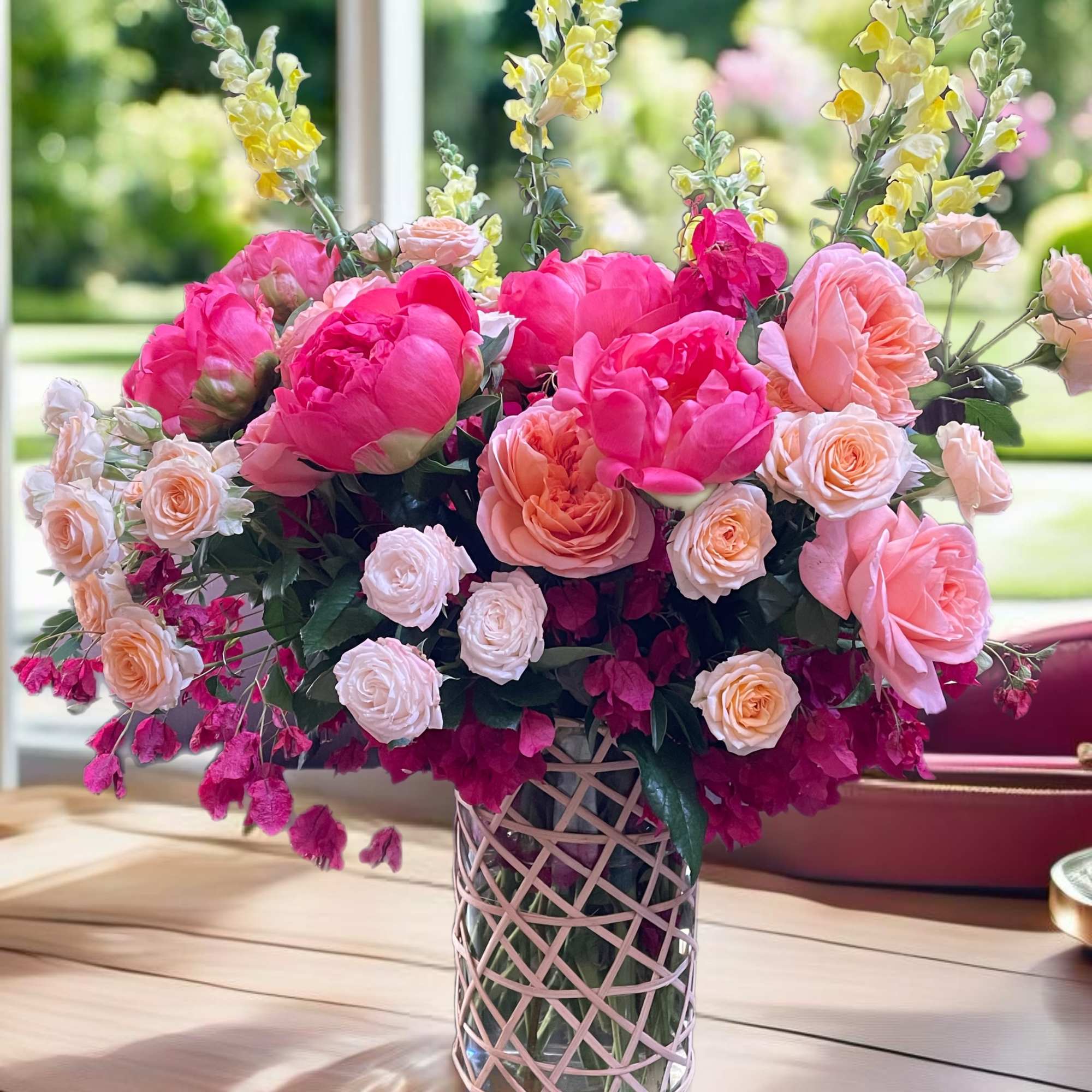 Pink and peach floral arrangement in a glass vase