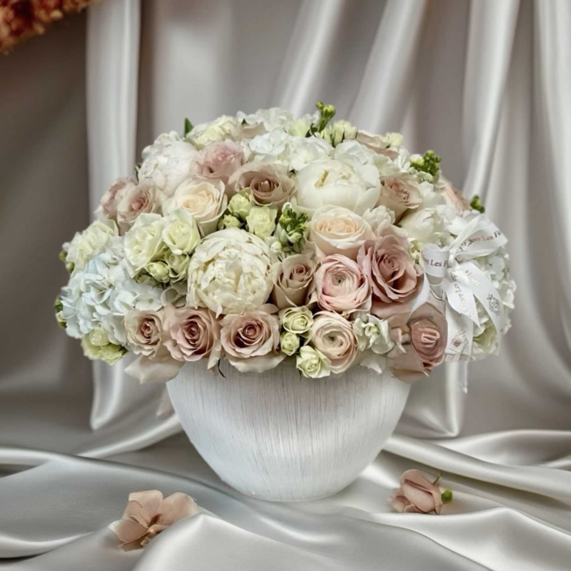 Blush and white rose bouquet in a white vase
