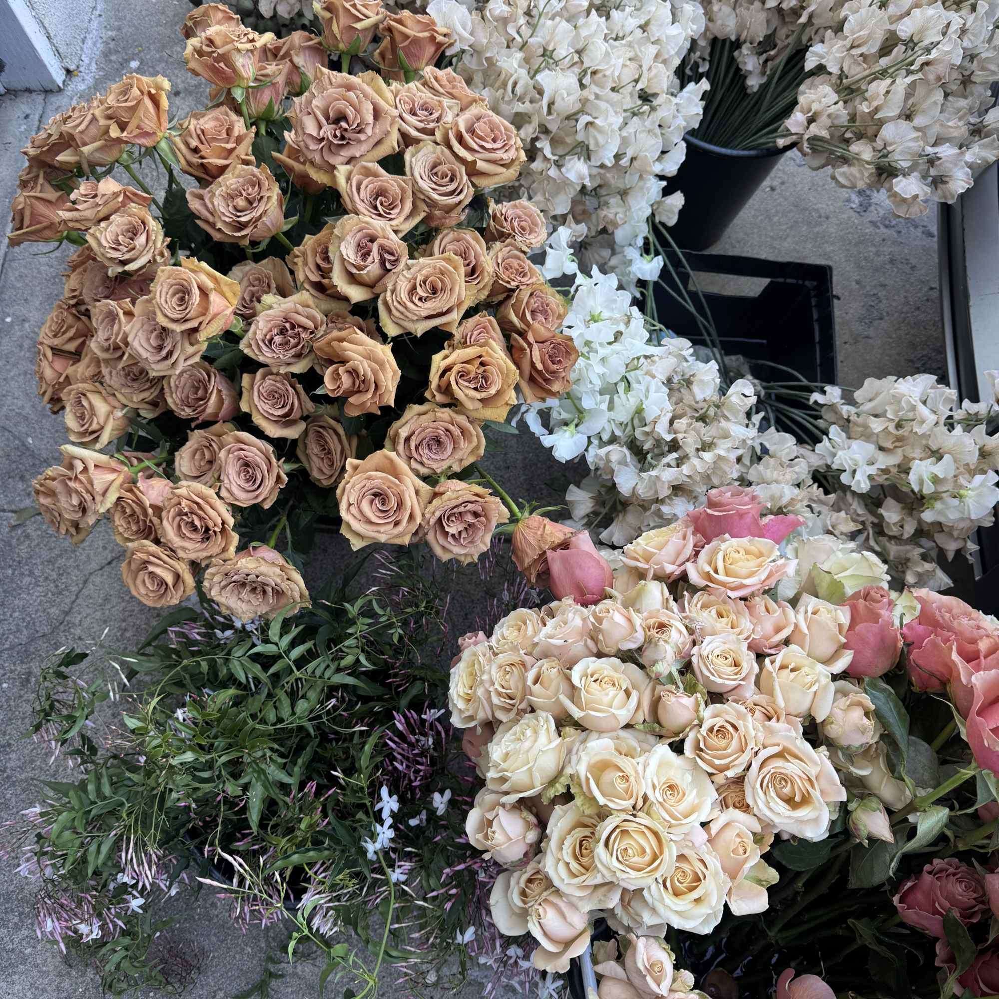 Assorted rose bouquets in blush, peach, and white tones