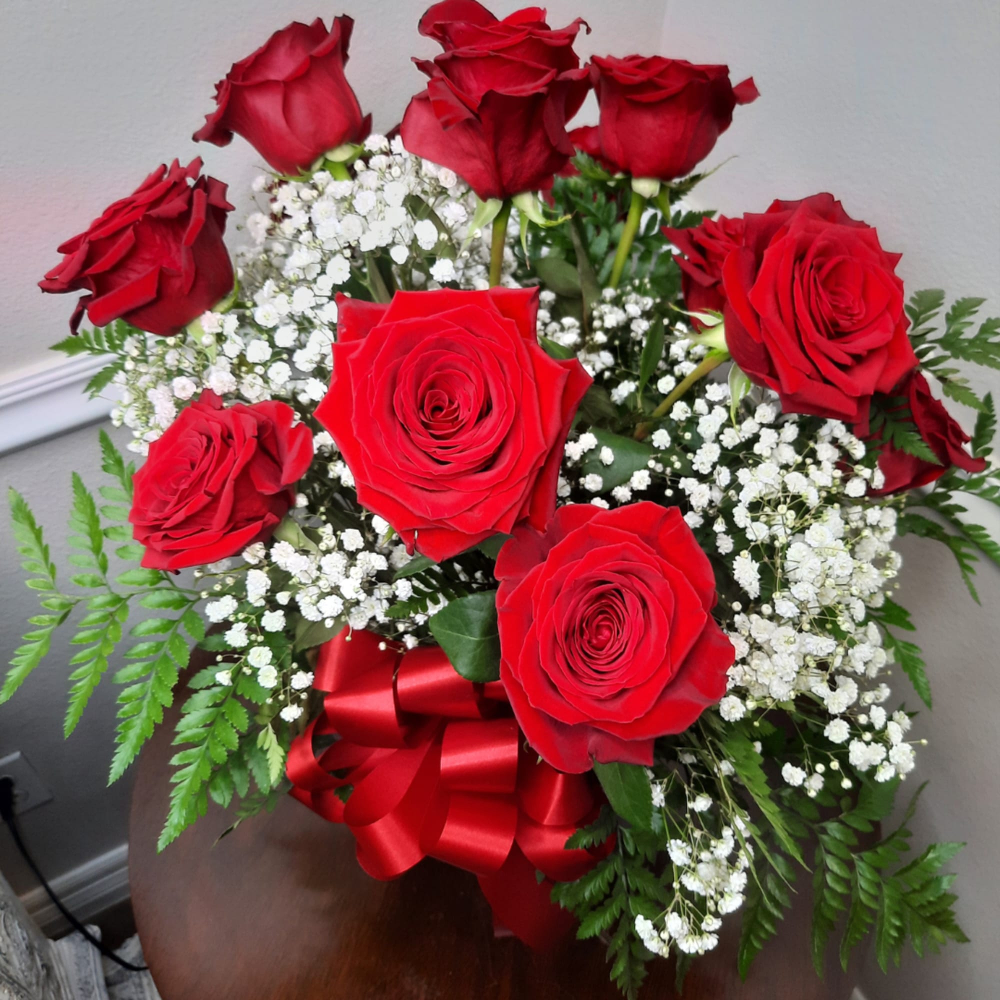 Bouquet of red roses with white baby's breath and a red ribbon