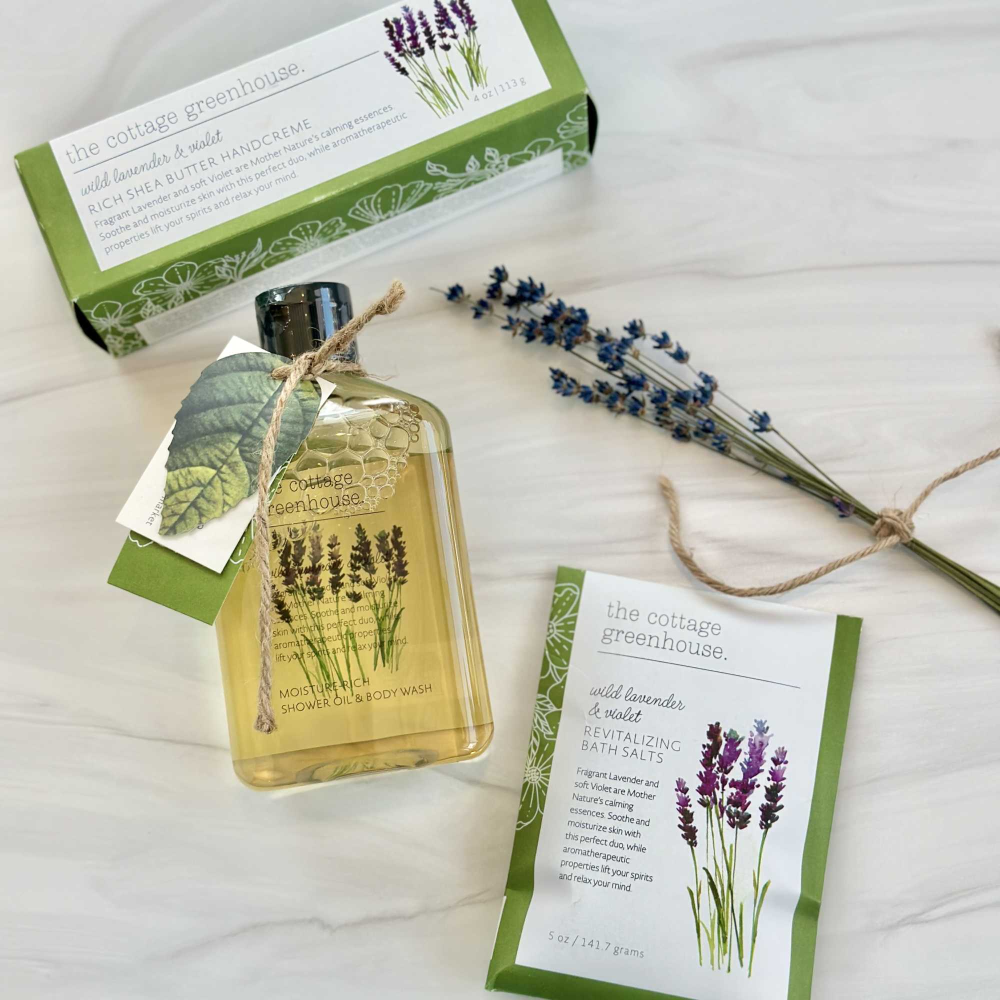 Lavender bath products with a bottle, salts pouch, and boxed hand cream