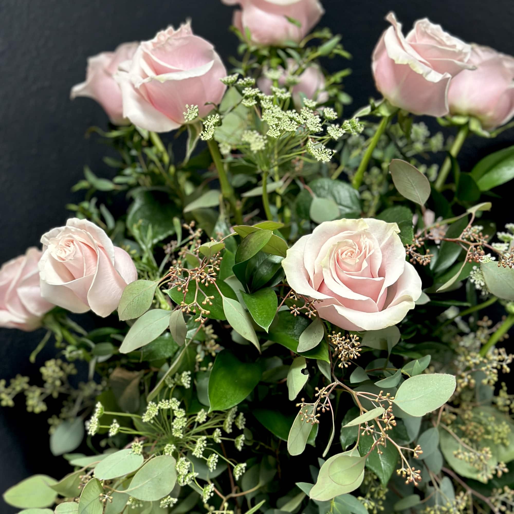 Bouquet of pale pink roses with mixed greenery