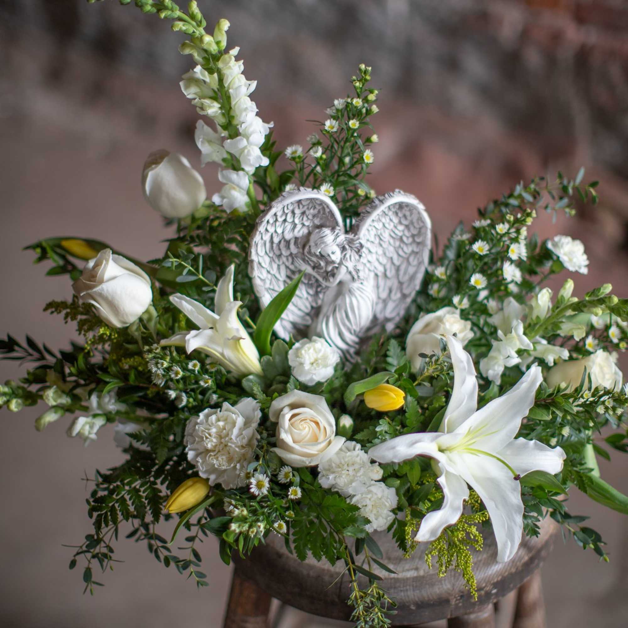 A lovely keepsake resin angel is nested into a garden floral design, photo 4 of 4