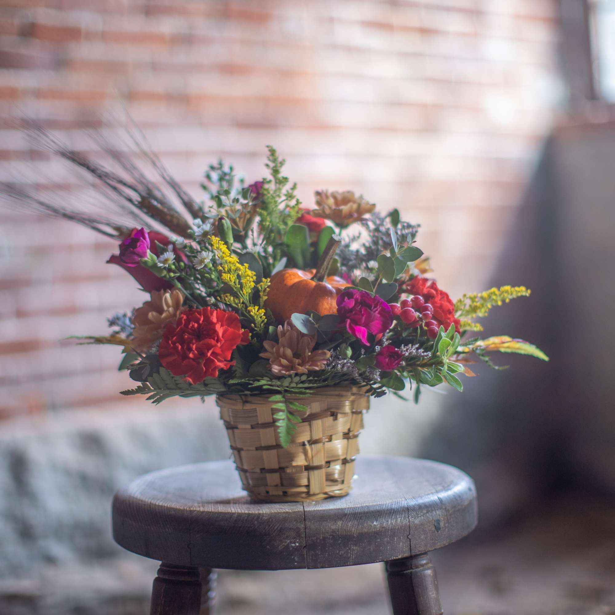 A mini pumpkin gourd pick is the focal point of the arrangement., photo 2 of 3