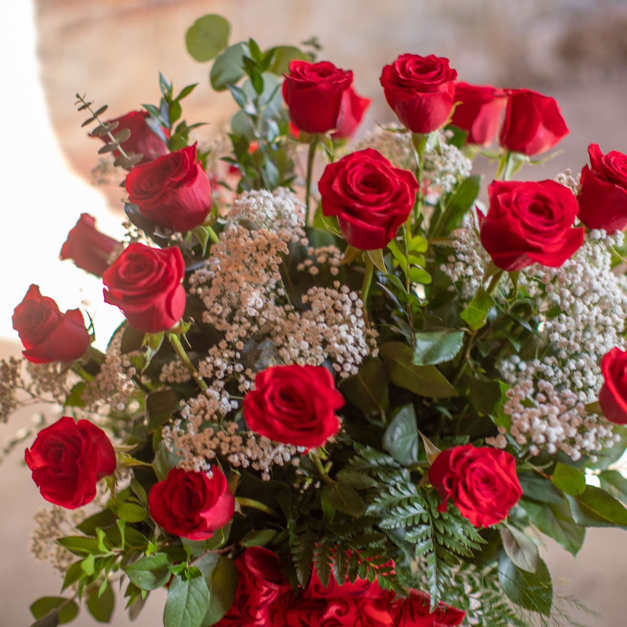 Bouquet of red roses with baby's breath and greenery