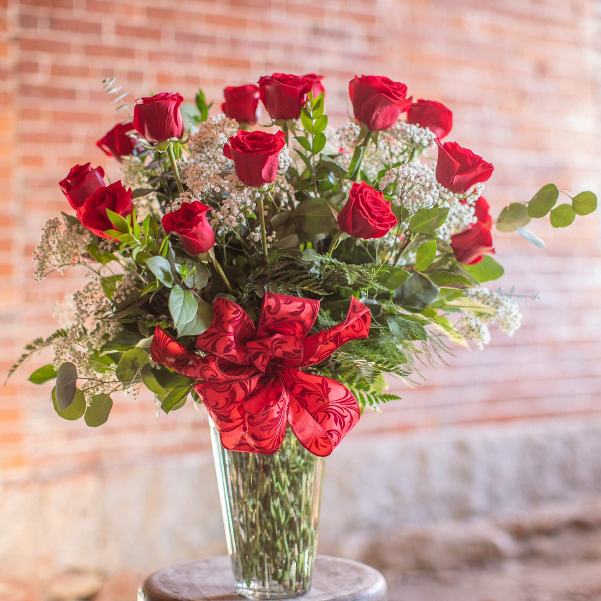 Bouquet of red roses in a clear glass vase with a red ribbon, photo 3 of 4