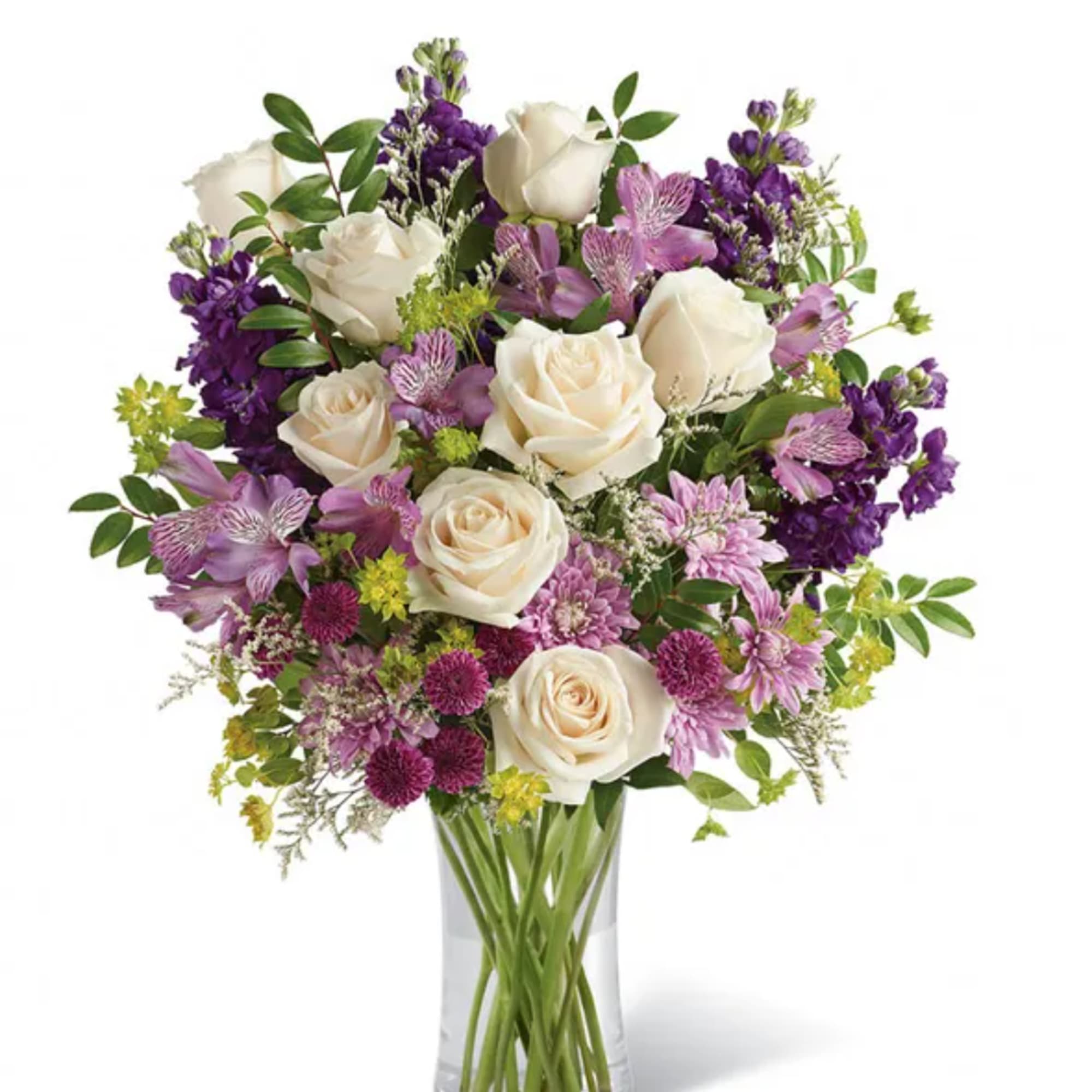 Bouquet of white roses and purple flowers in a clear glass vase