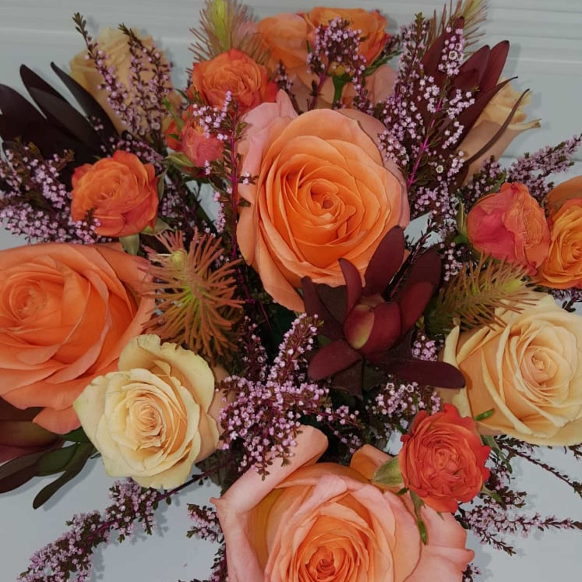 Warm Peach toned flowers in a square wooden vase, photo 2 of 3