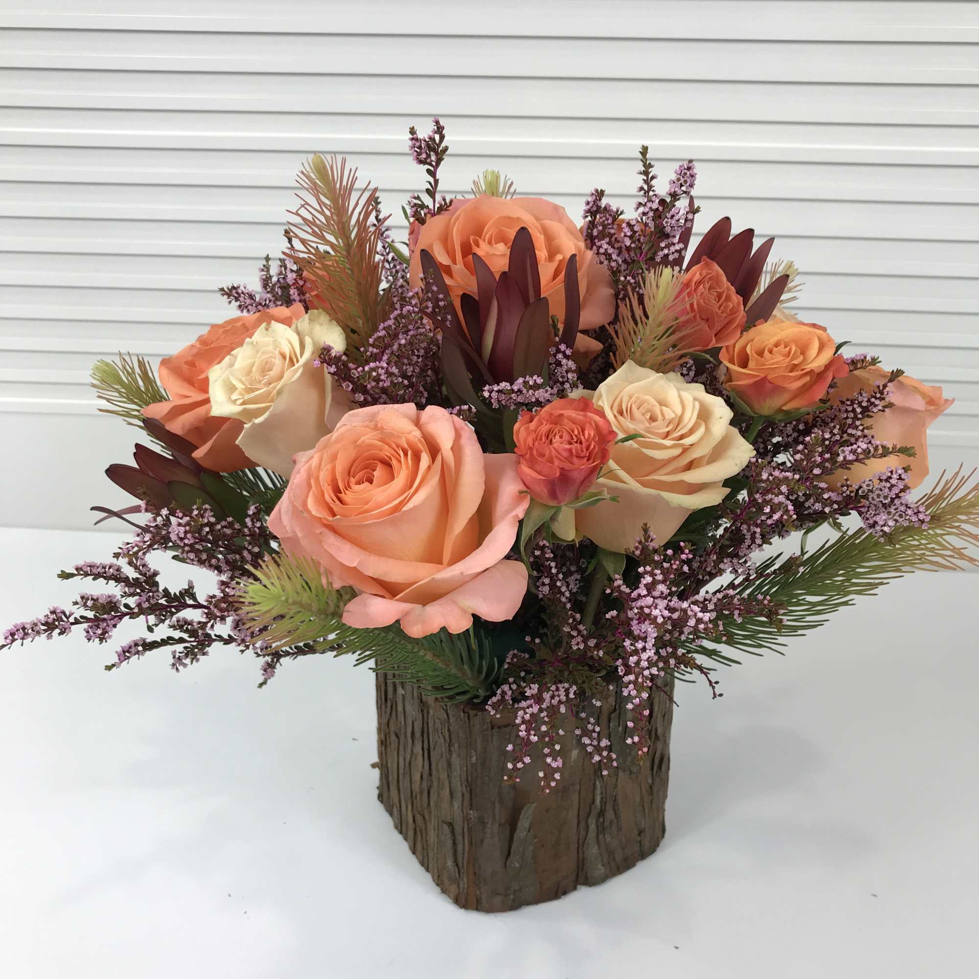 Warm Peach toned flowers in a square wooden vase, photo 3 of 3