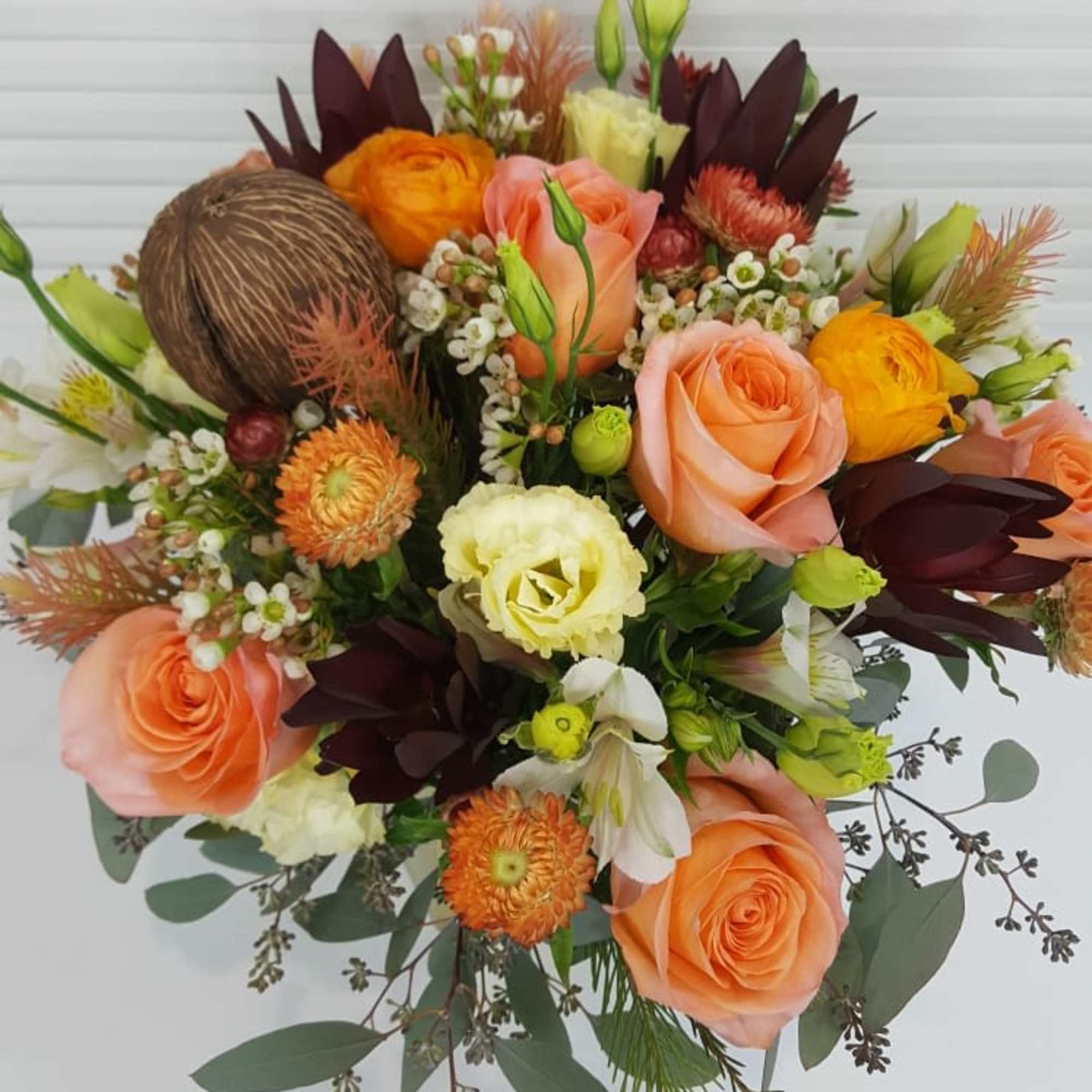 Collection of peach colored roses, ranunculus, alstroemeria, Lisianthus, wax flowers, and more, photo 2 of 3