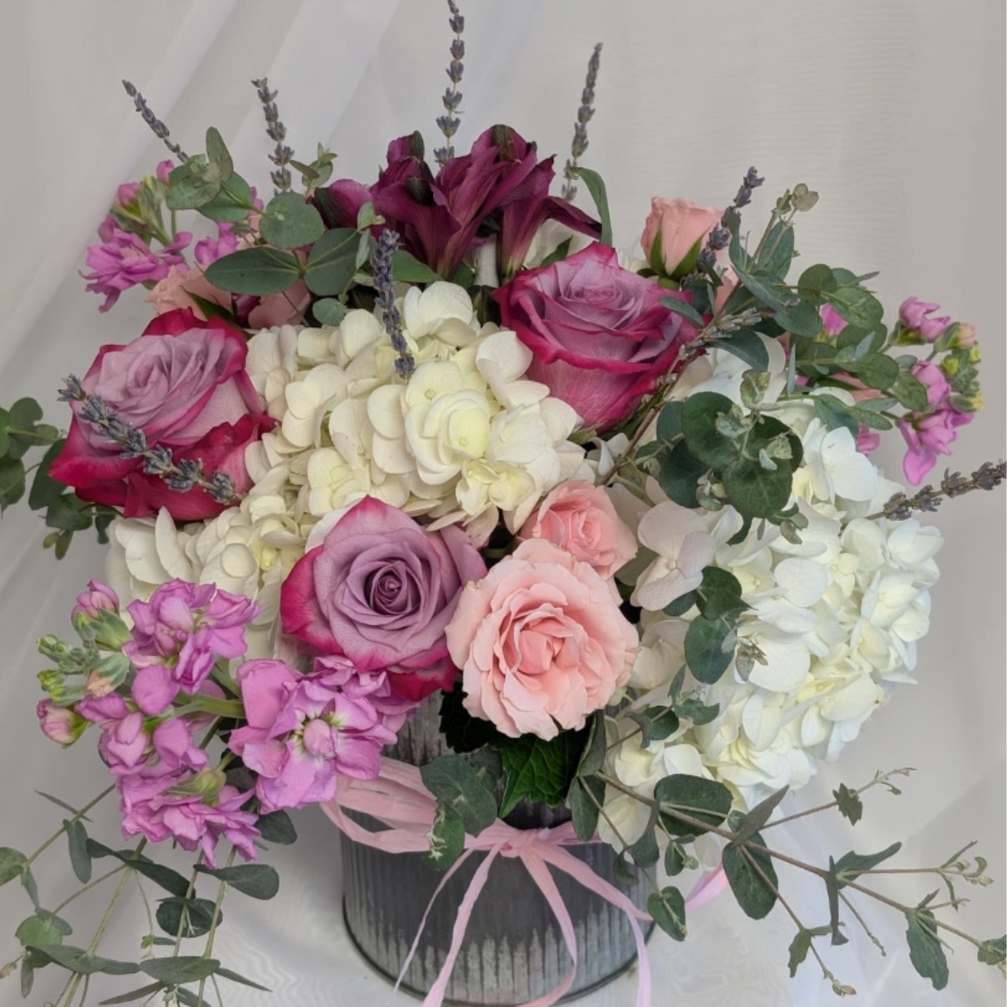 Collection of Hydrangea, Spray Roses, lavender,  in an old fashioned rustic