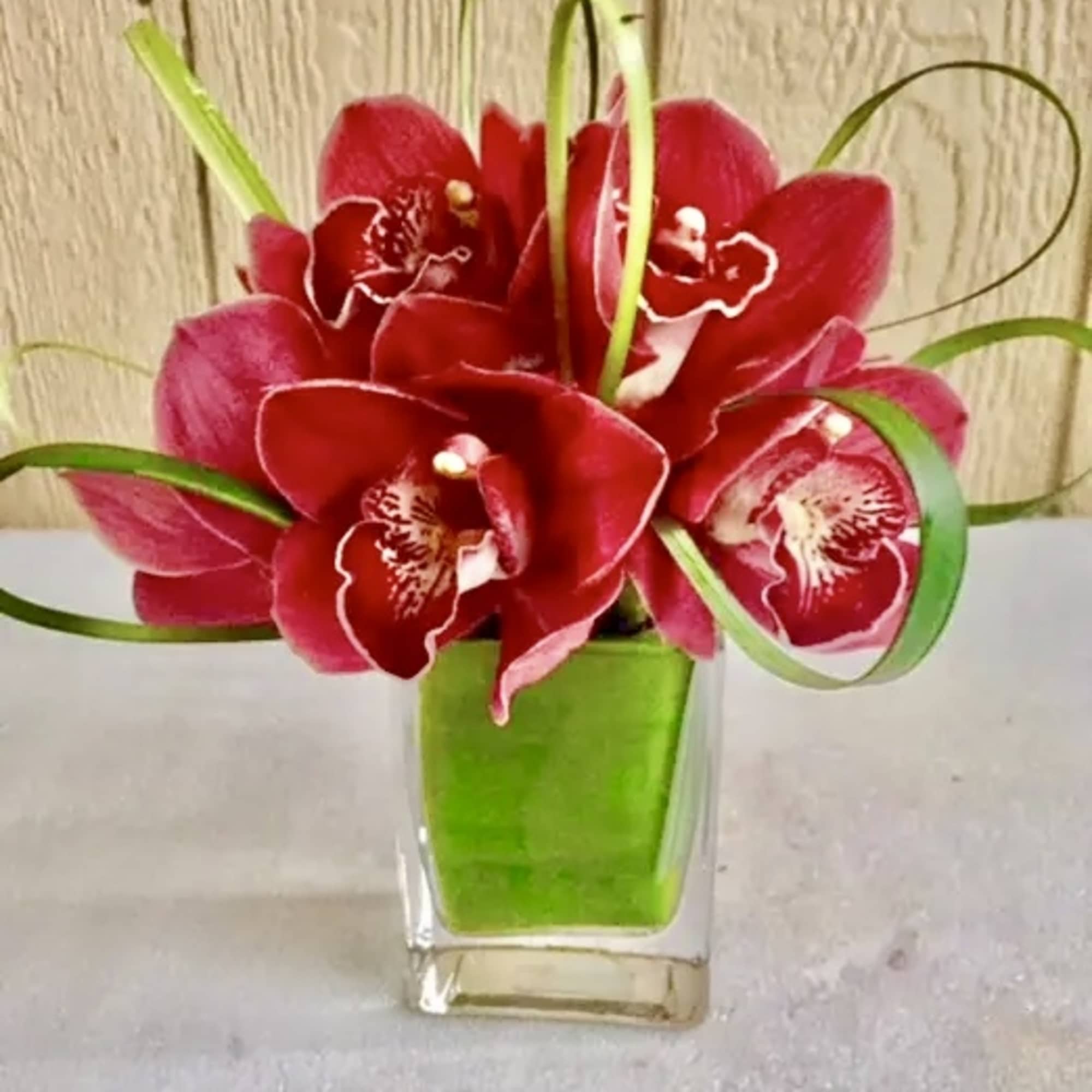 In the glass ways combinations of seven Cymbidium burgundy orchids with a