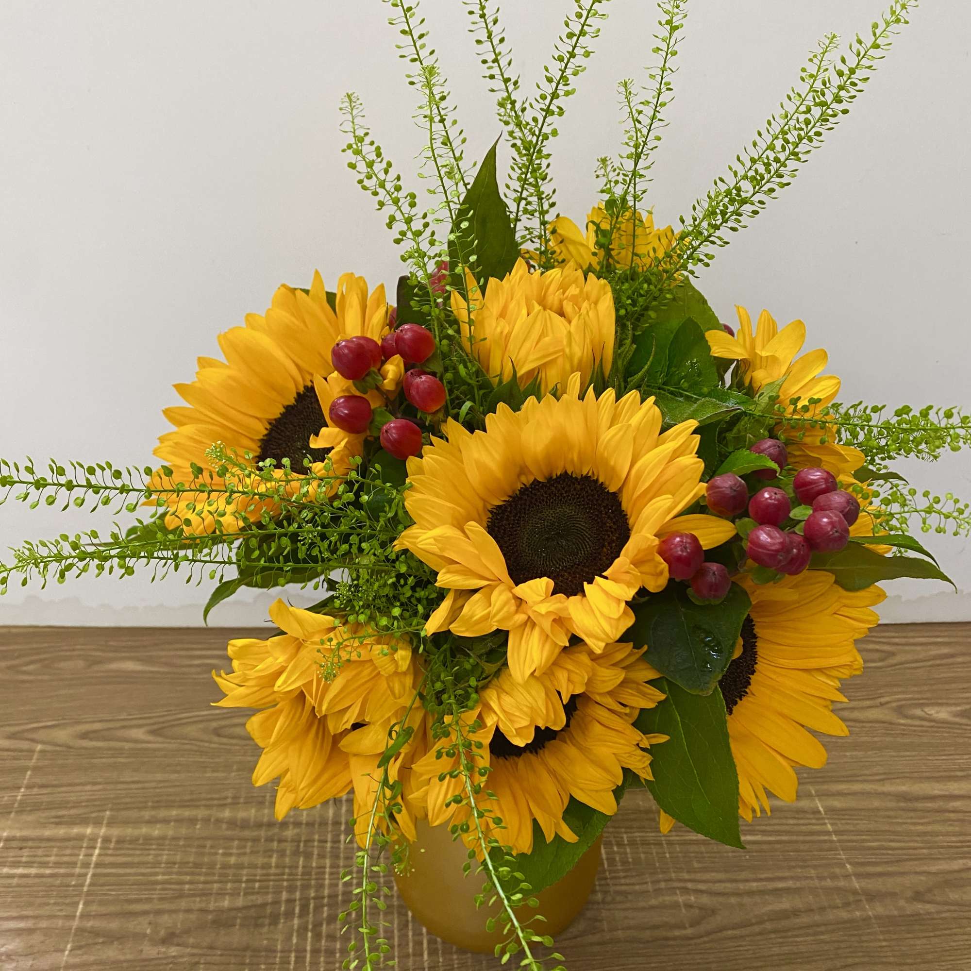 Bright, cheerful, and full of sunshine, this arrangement features seven radiant sunflowers