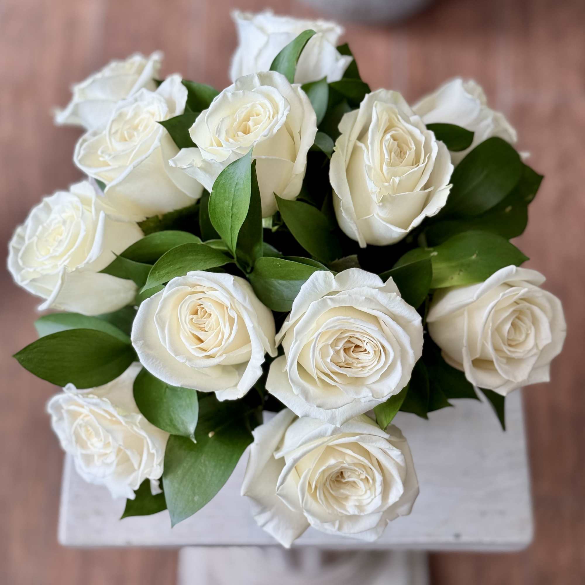 Bouquet of white roses with green leaves