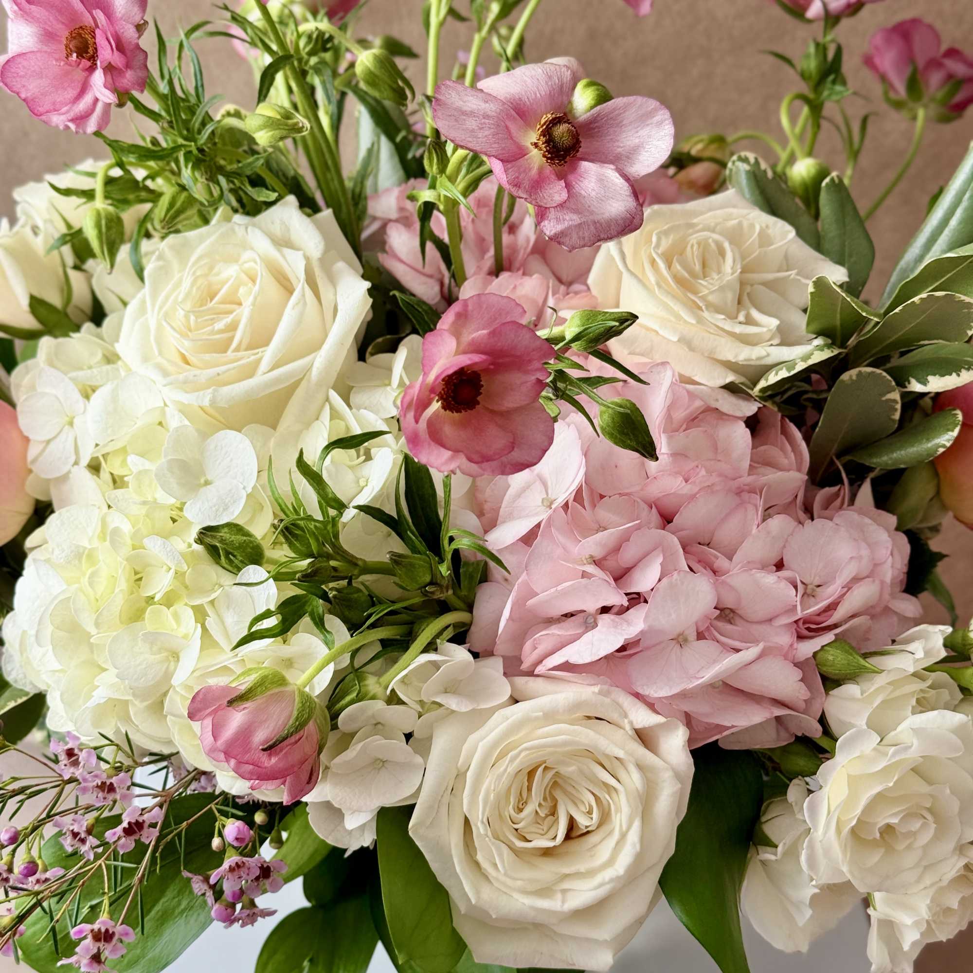 Pink and white bouquet with roses, hydrangea, and small pink blooms