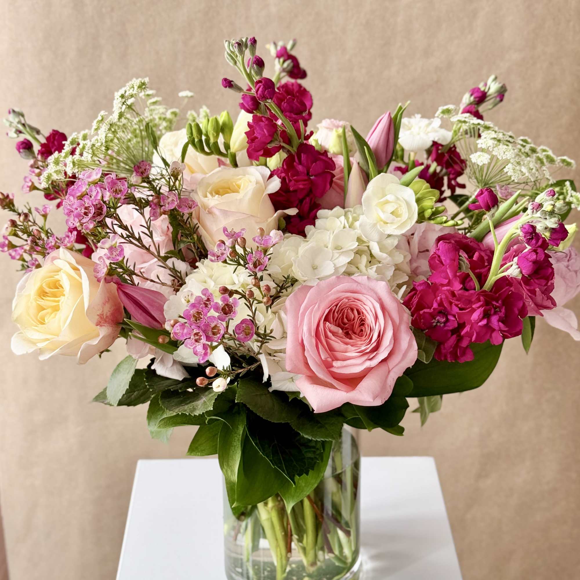 Pink and white mixed flower bouquet in a clear glass vase