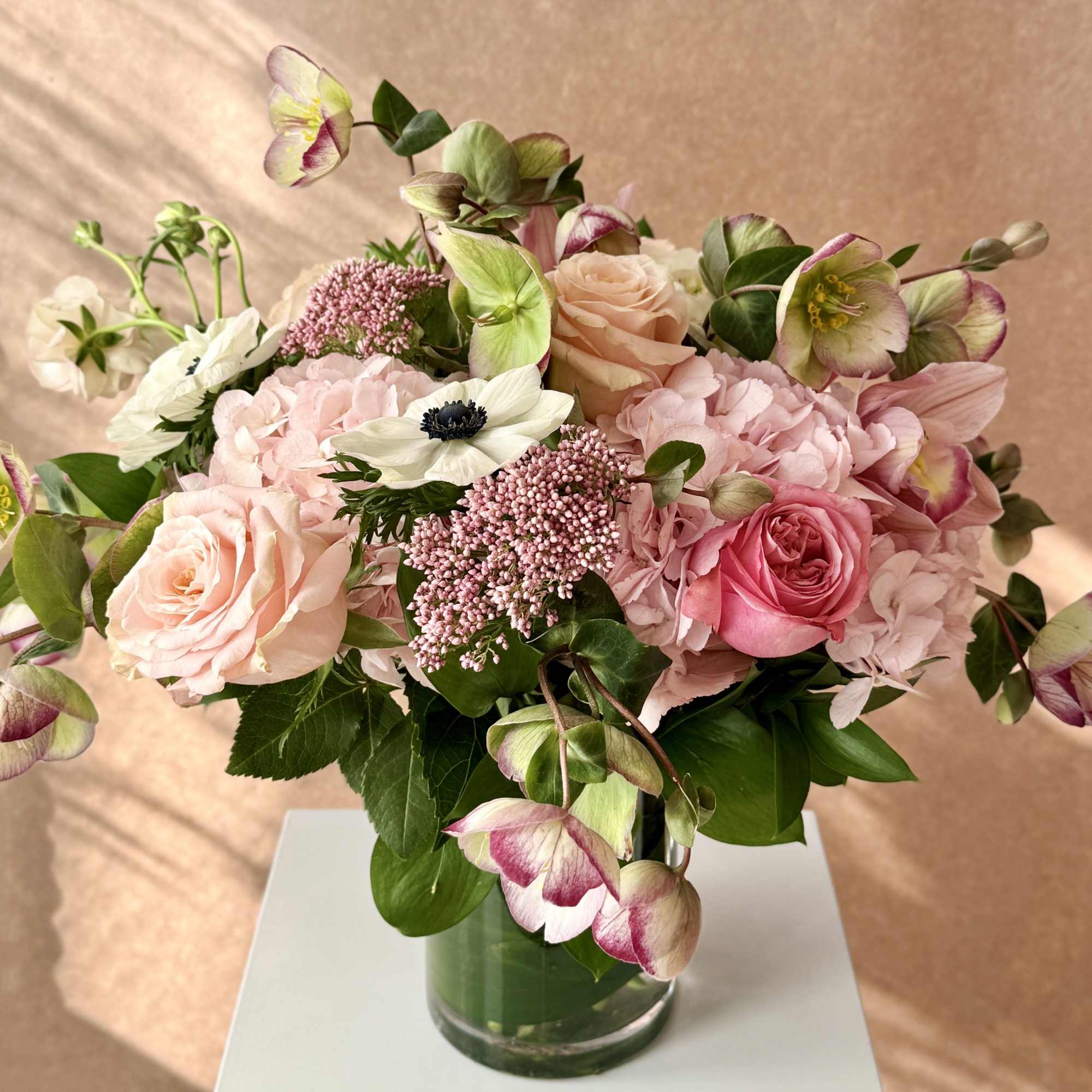 Pink and white floral arrangement in a glass vase