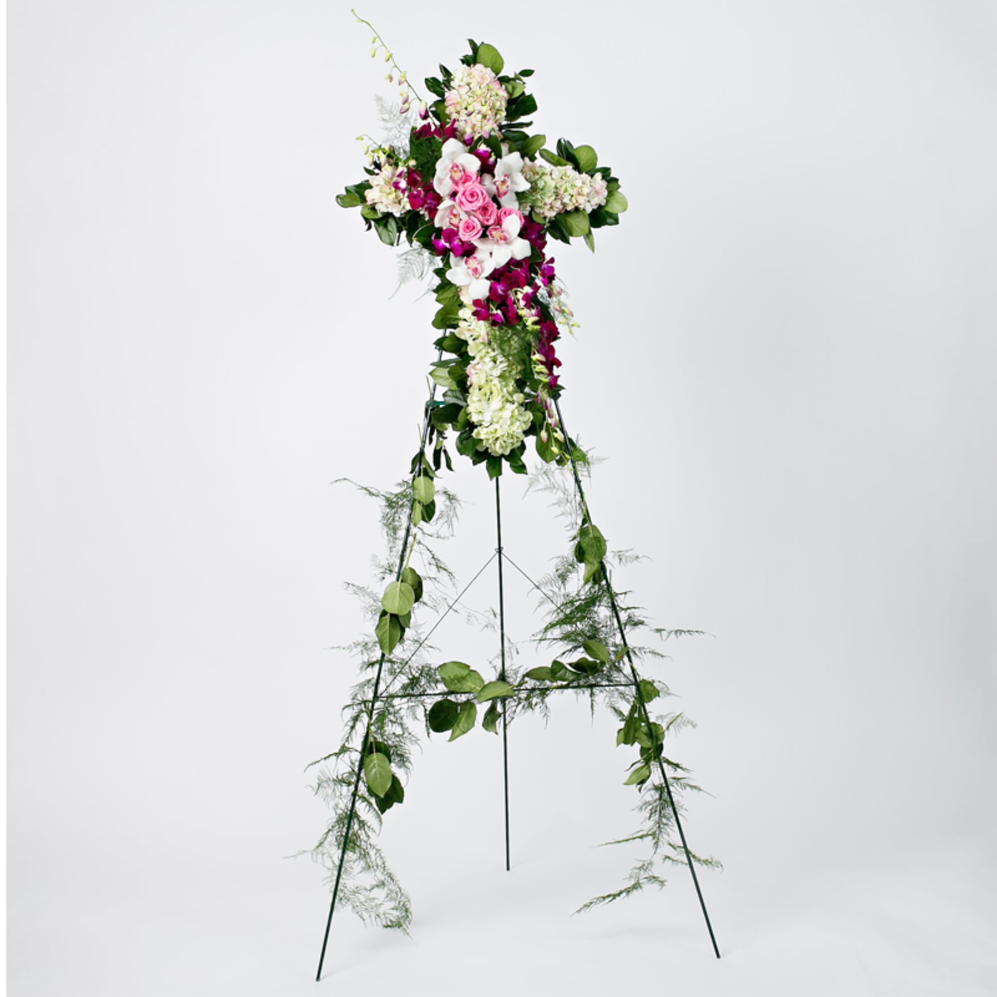 Tall floral standing spray on an easel with pink, white, and purple flowers