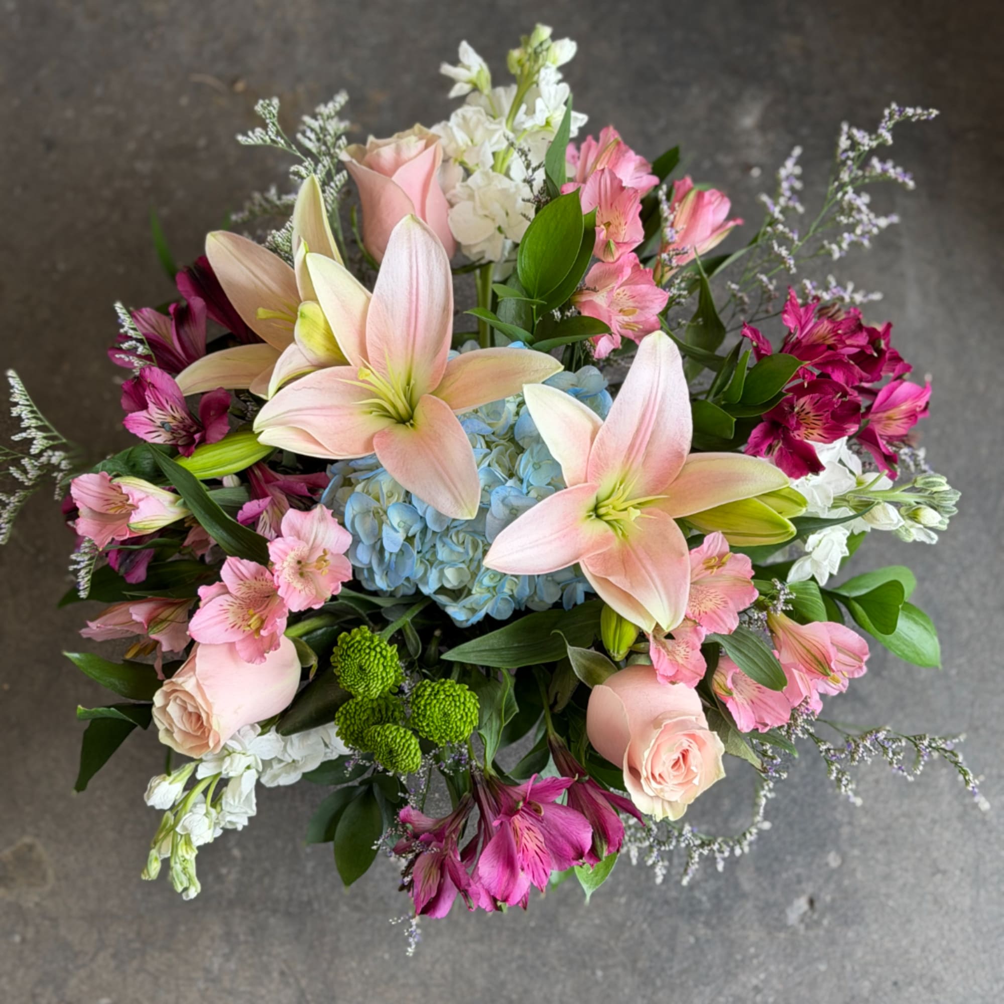 Mixed bouquet with pink lilies, roses, hydrangea, and alstroemeria