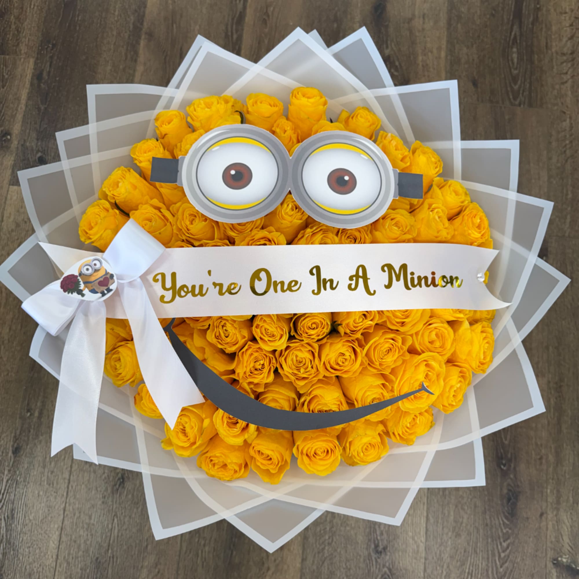 Yellow rose bouquet with Minion face decoration and white ribbon