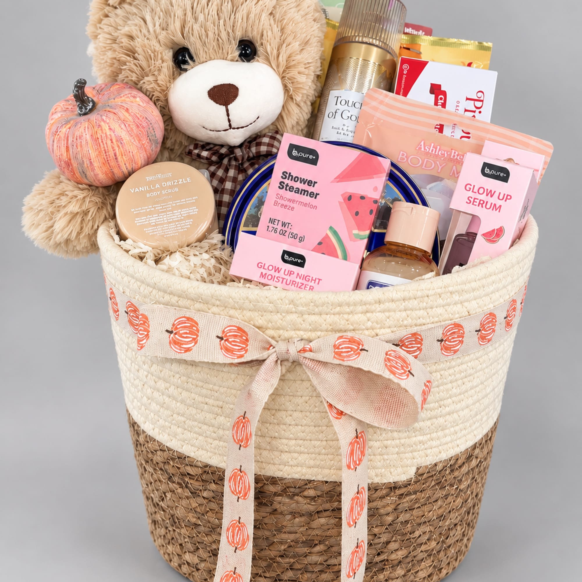 Gift basket with a teddy bear, pumpkin decor, and assorted bath products