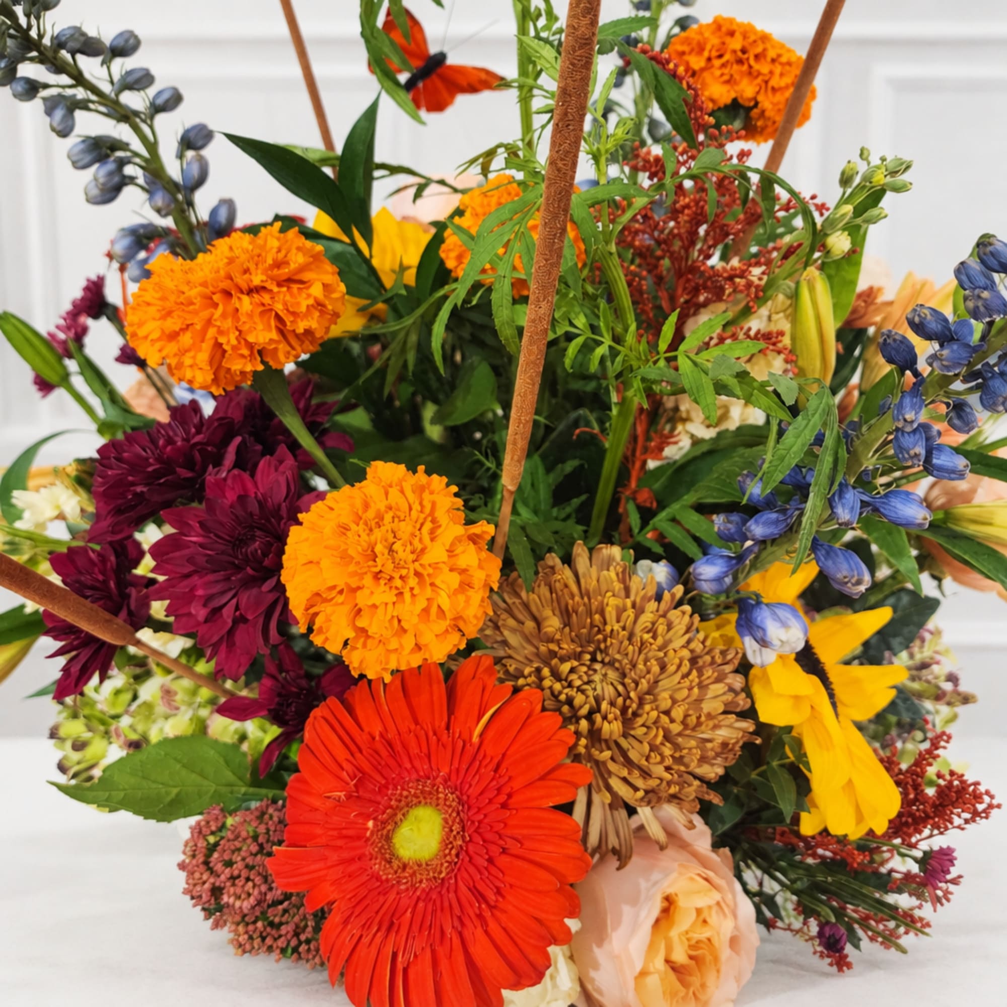 Mixed bouquet with orange, purple, yellow, and blue flowers