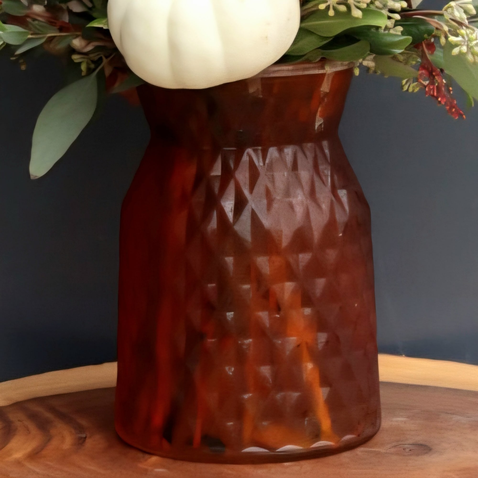 White pumpkin arrangement in an amber textured vase
