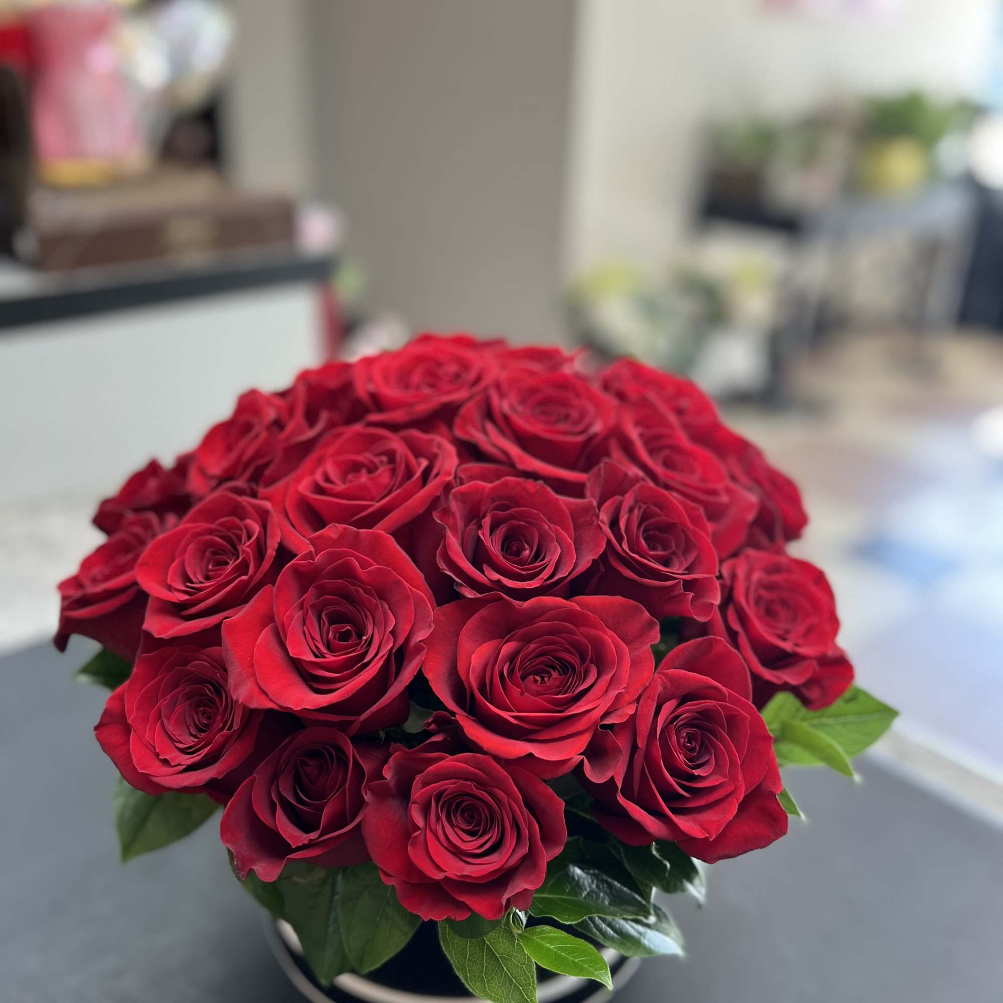 Bouquet of red roses in a low round container