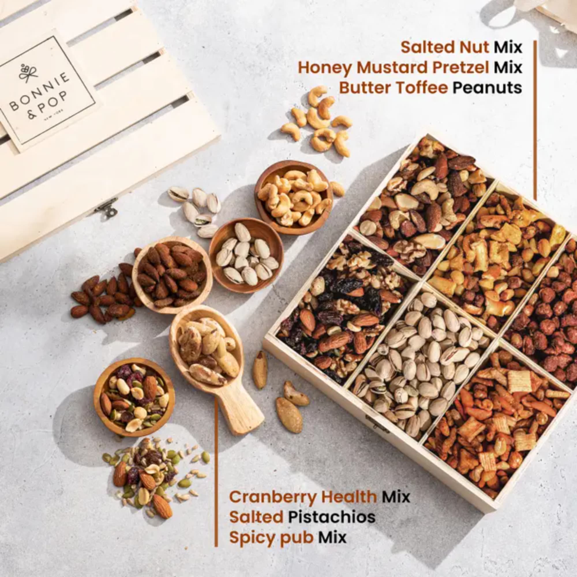 Assorted nuts and snack mixes in bowls and a divided gift box