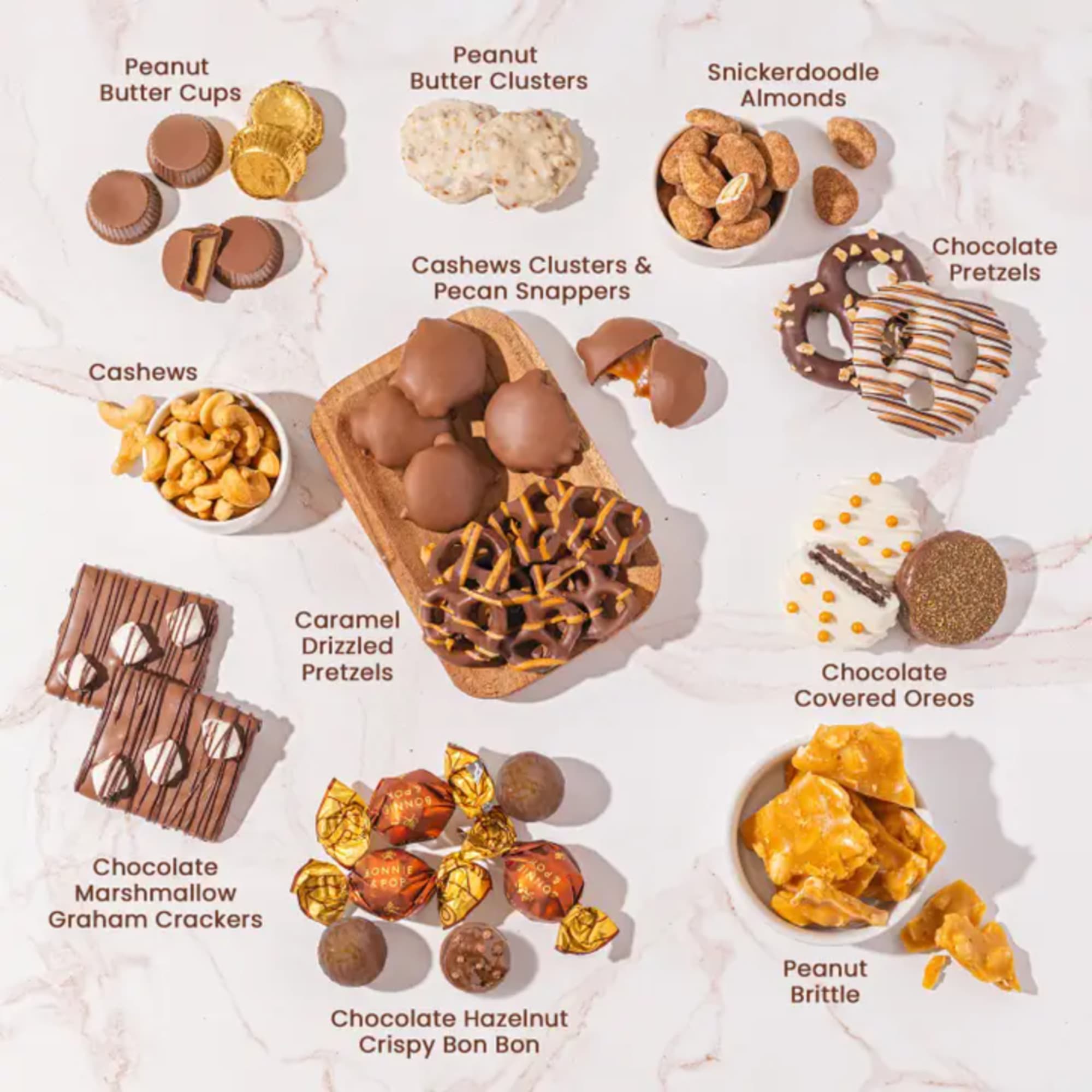 Assorted chocolate-covered snacks and nuts arranged on a light surface
