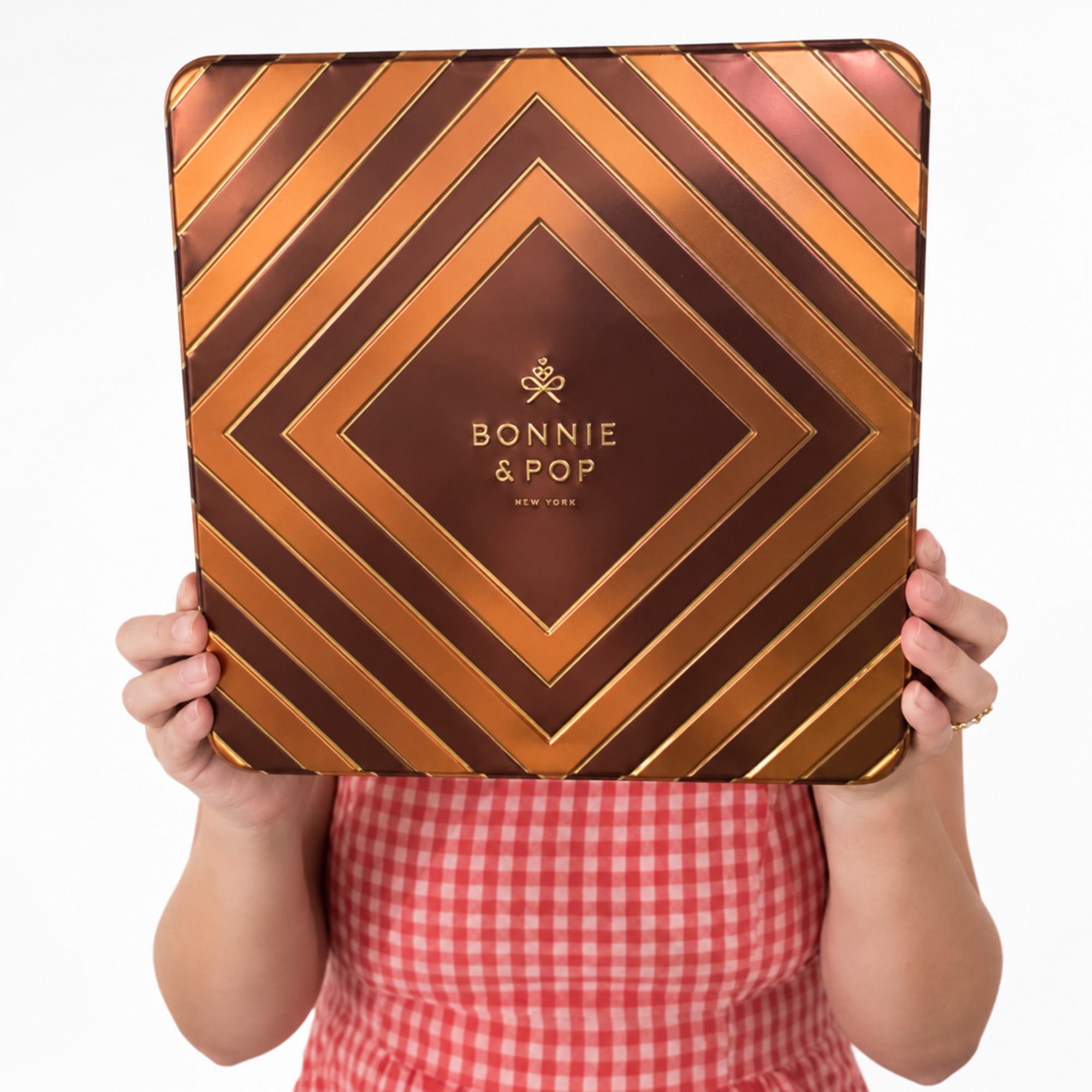 Person holding a large Bonnie & Pop gift tin