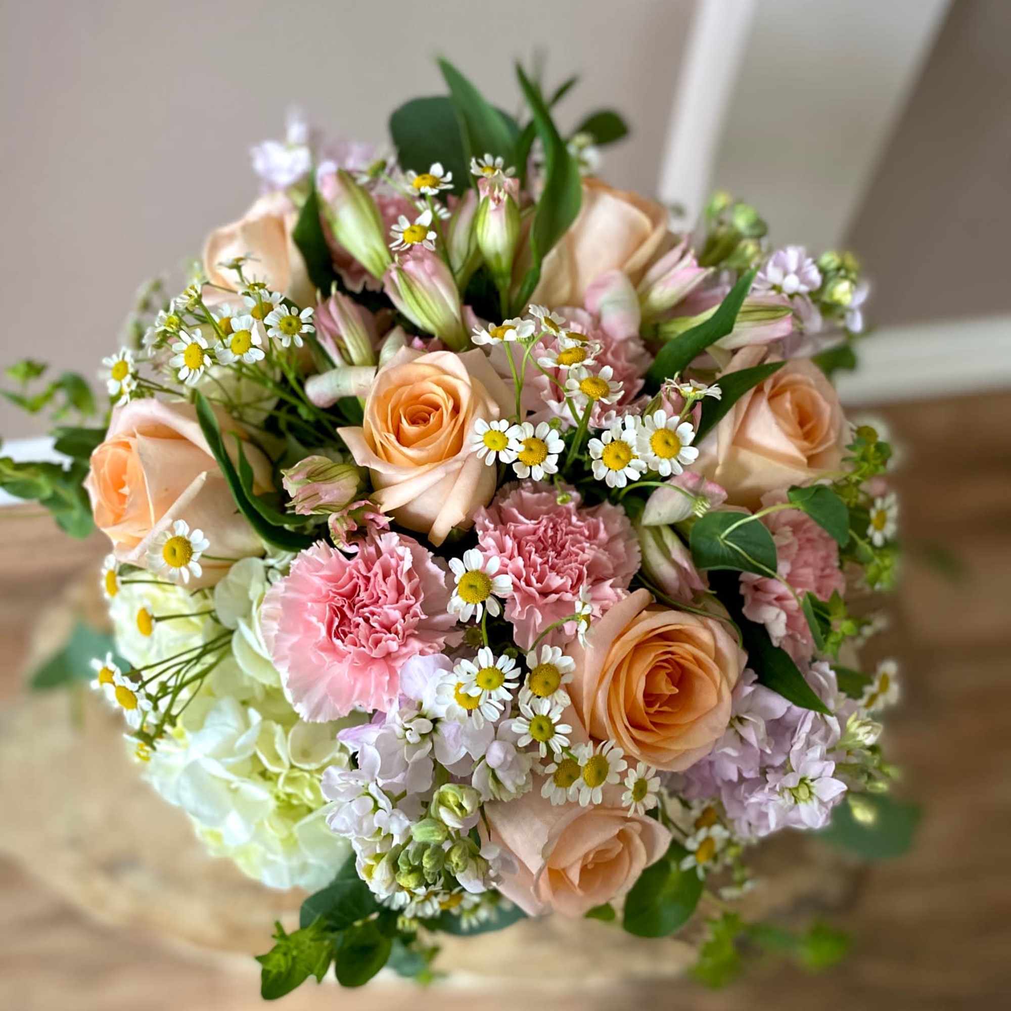 Bouquet of peach roses, pink carnations, and small white daisies, photo 2 of 3