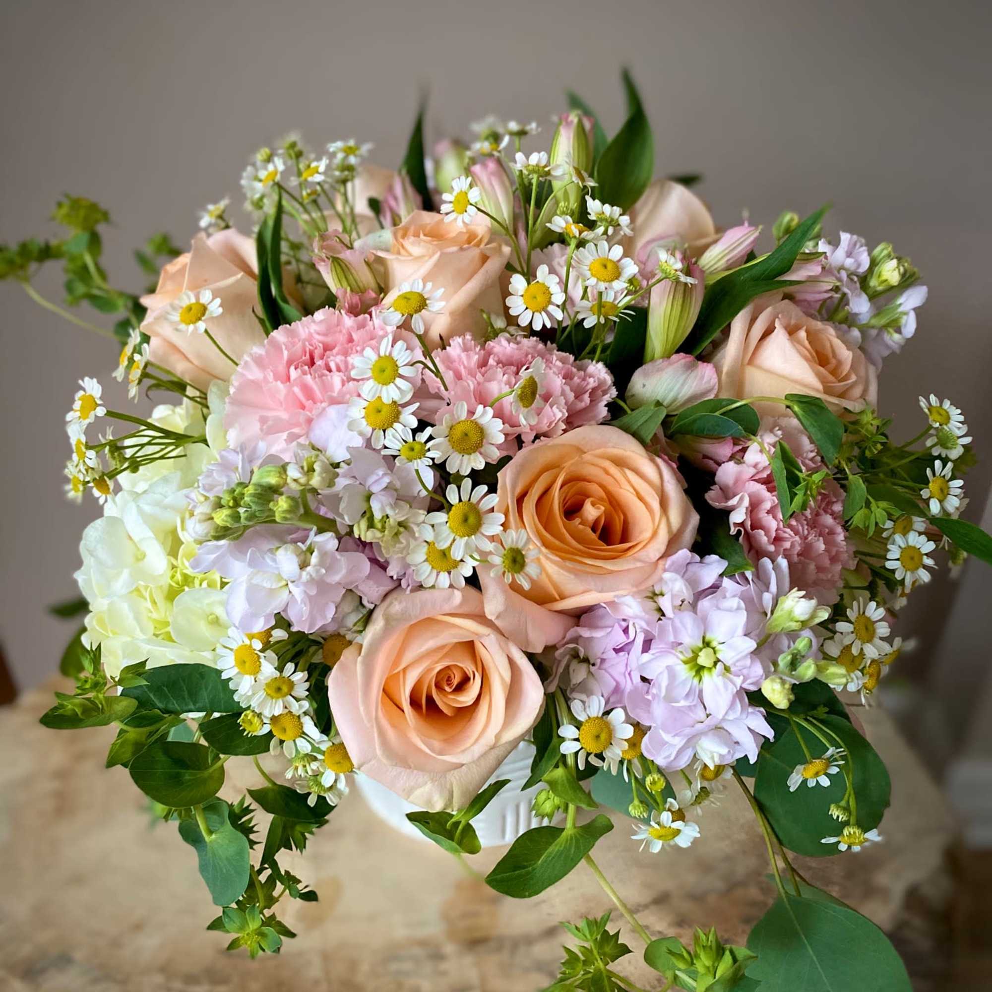 Bouquet of peach roses, pink carnations, and small white daisies, photo 3 of 3