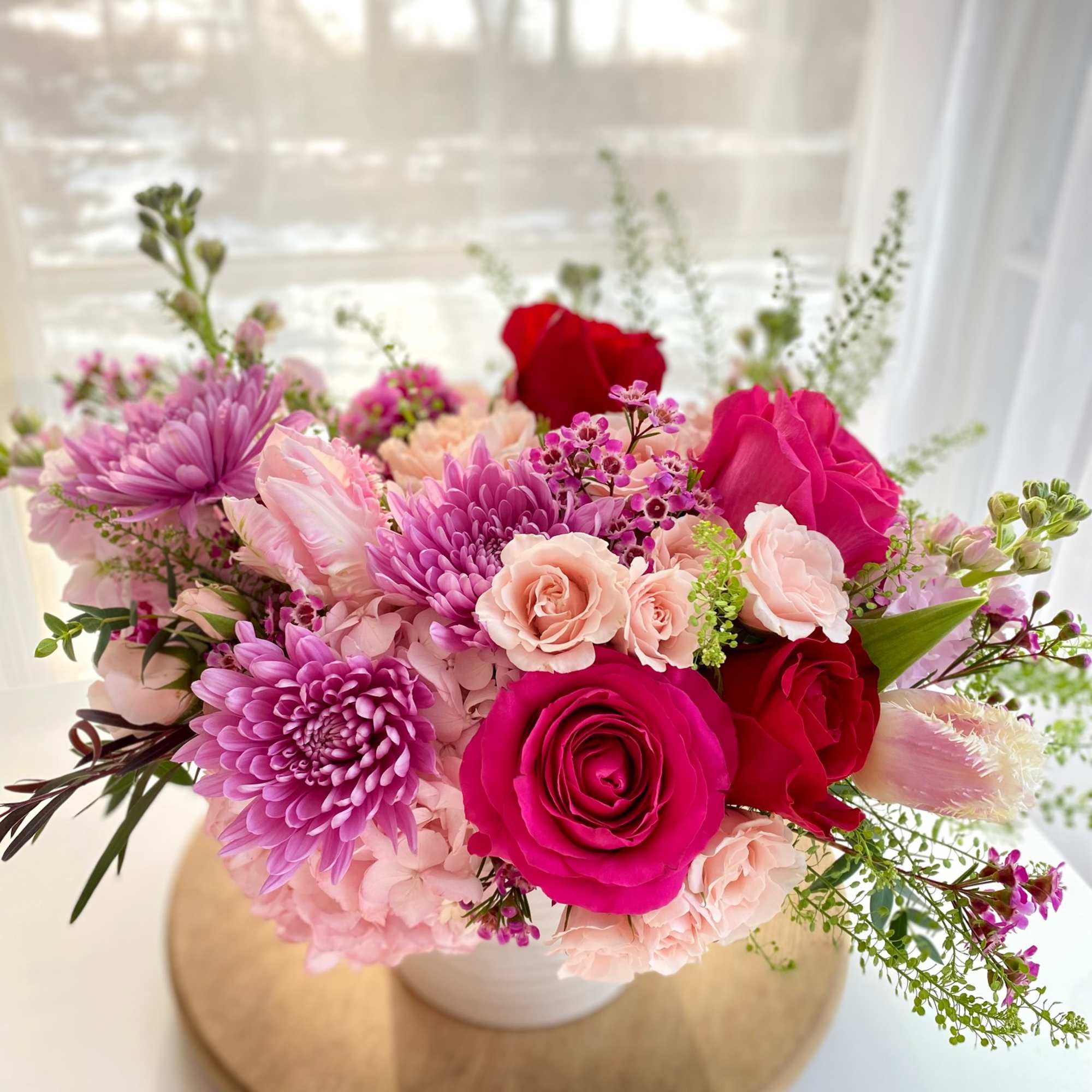 Pink and red mixed bouquet in a white vase