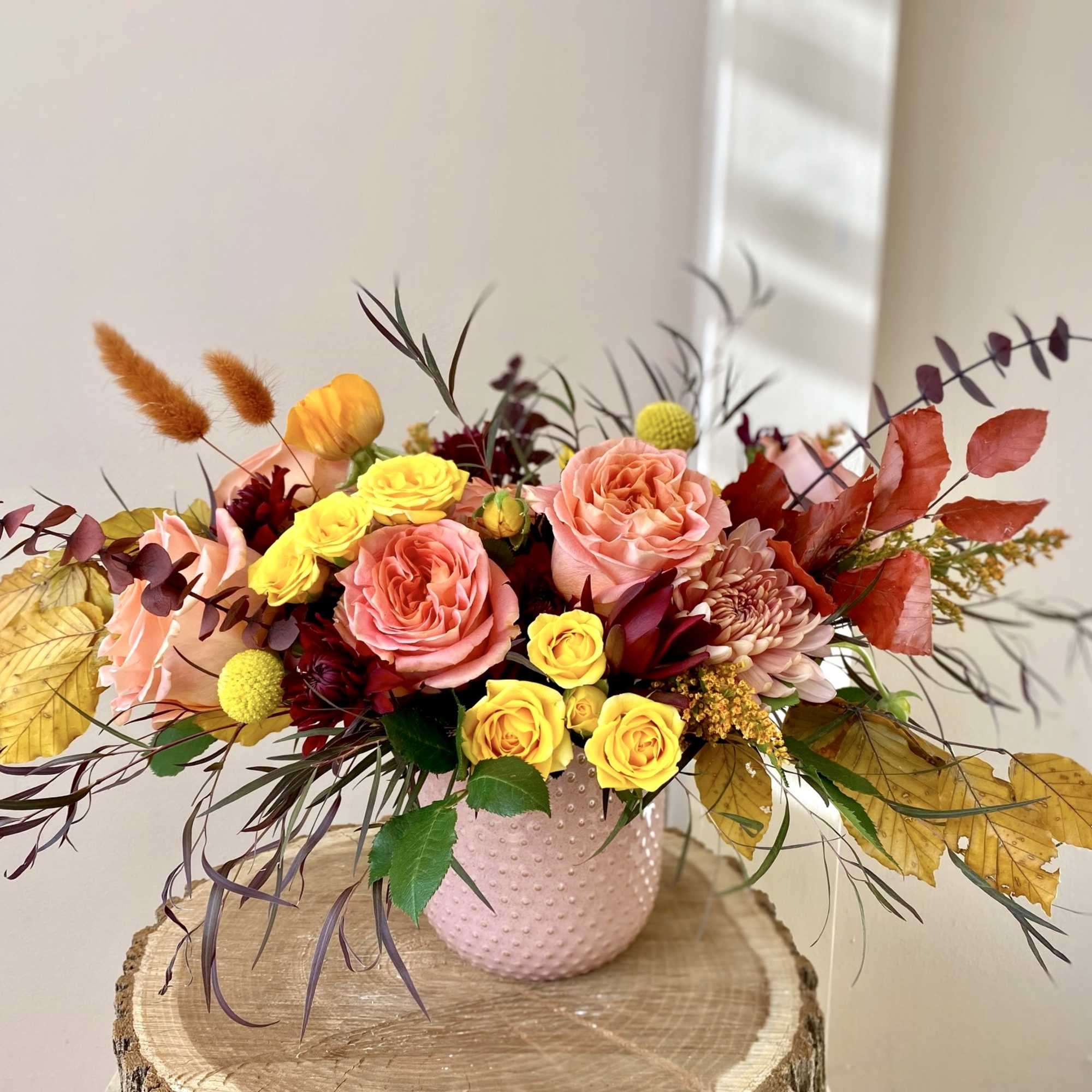 This cute and colorful arrangement will hug your loved one's heart and