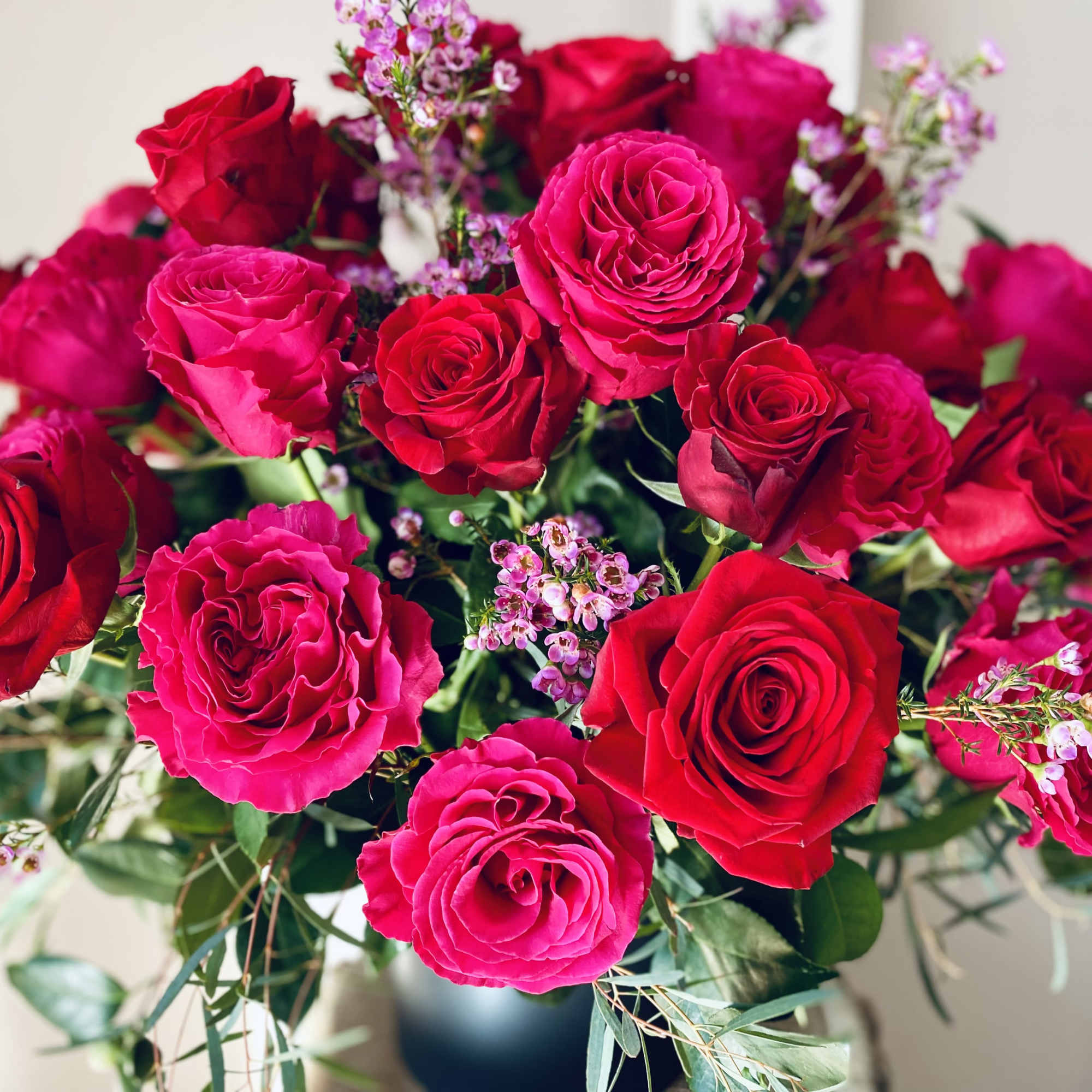 Bouquet of red and pink roses with small filler flowers