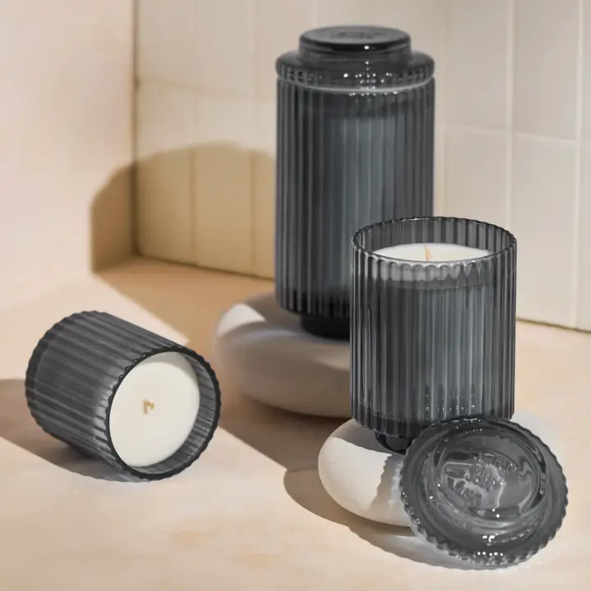 Three ribbed glass candles in dark gray and white