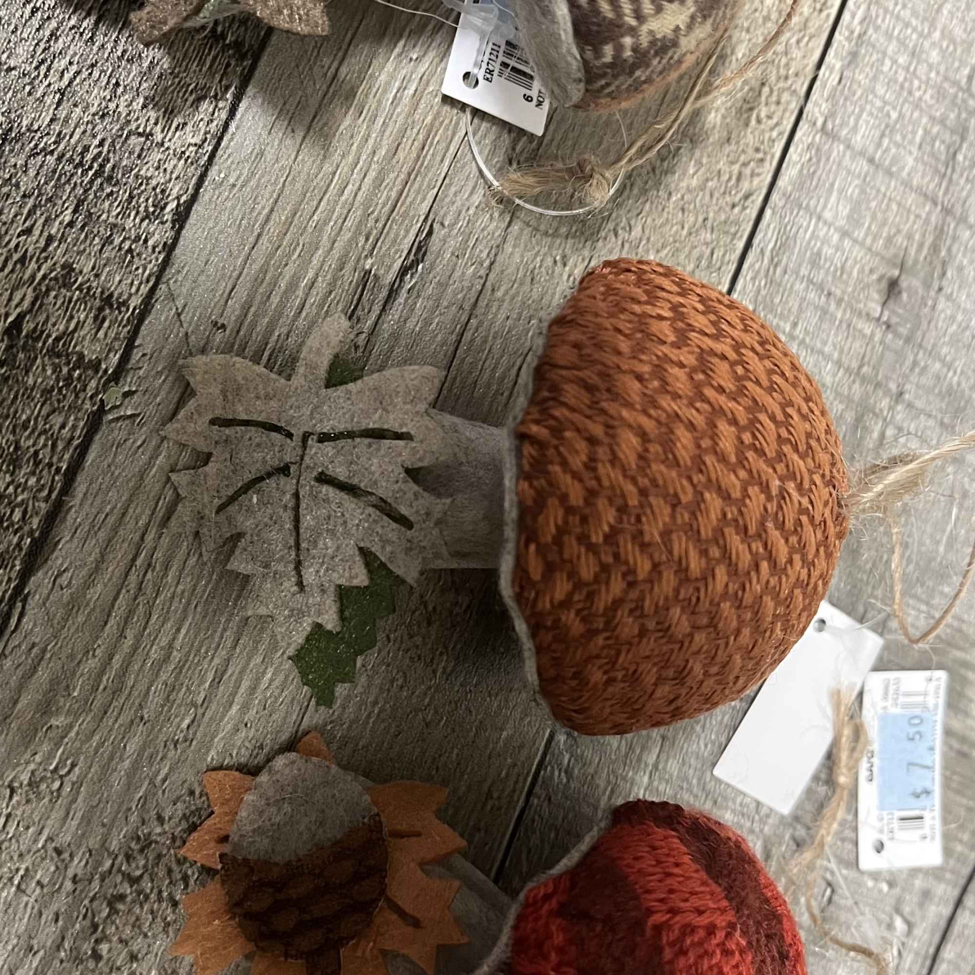 Decorative fabric acorns in autumn colors on a wood floor