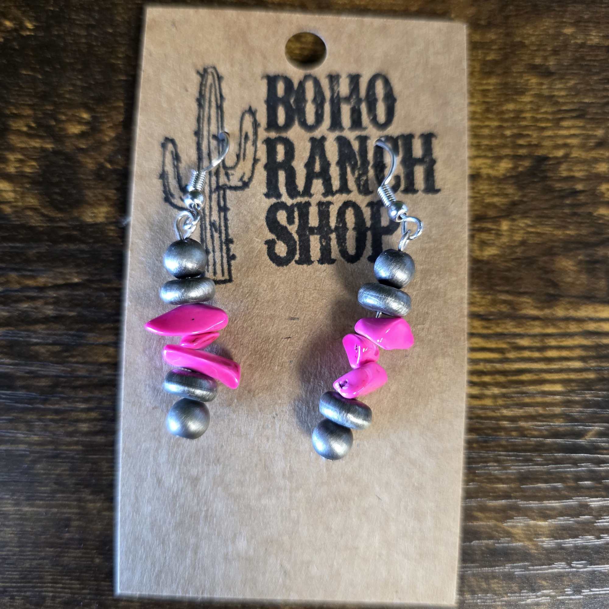 Pair of beaded earrings on a cardboard display card