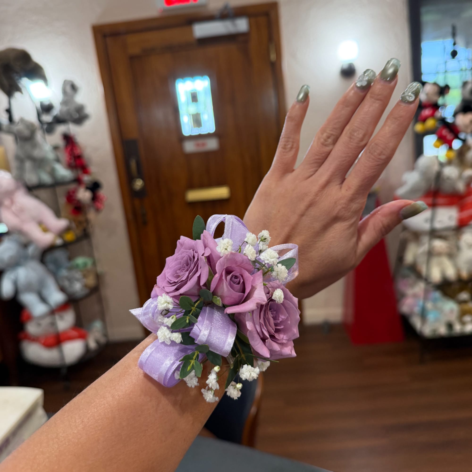 Lavender rose wrist corsage with ribbon and baby's breath
