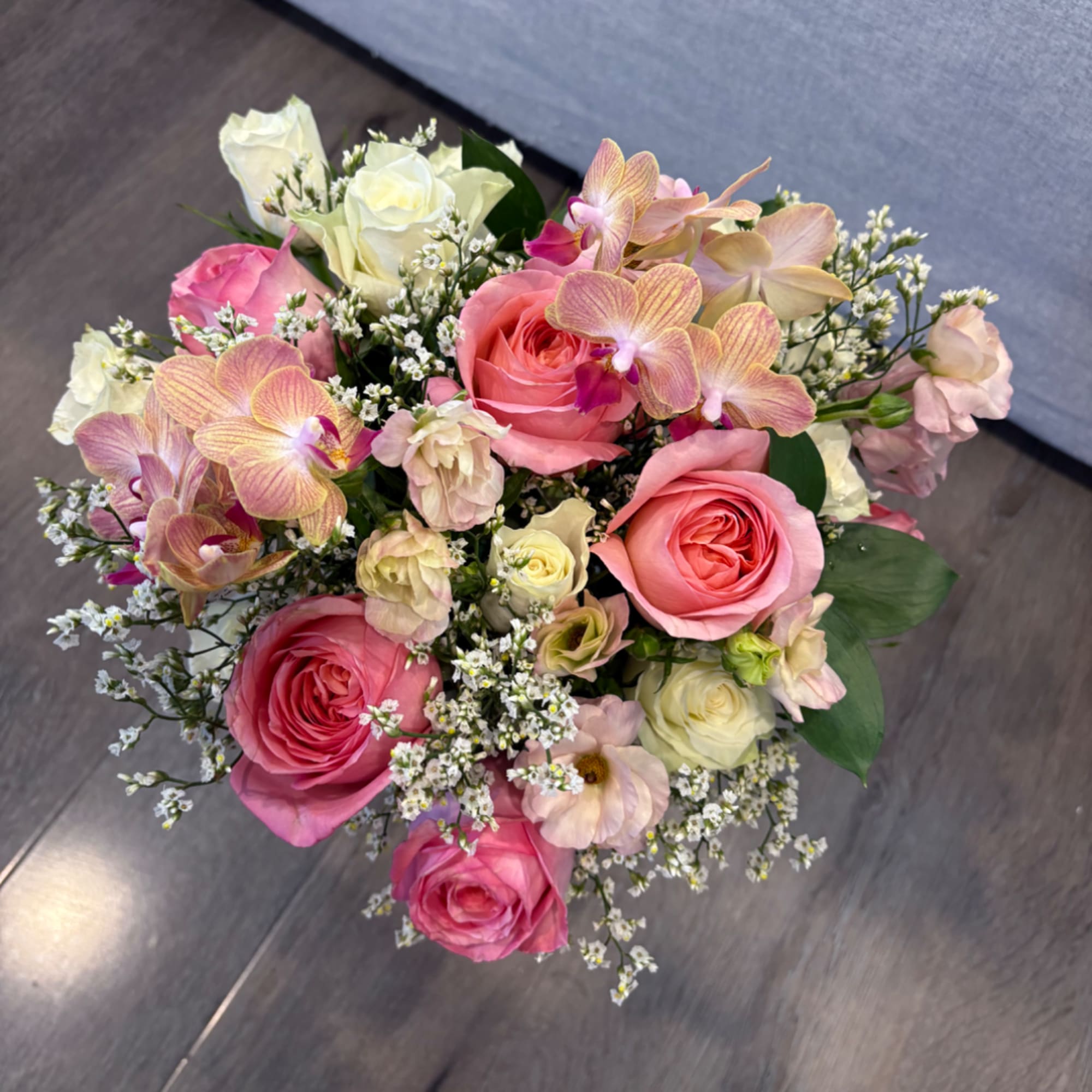 Pink and white rose bouquet with orchids and small filler flowers