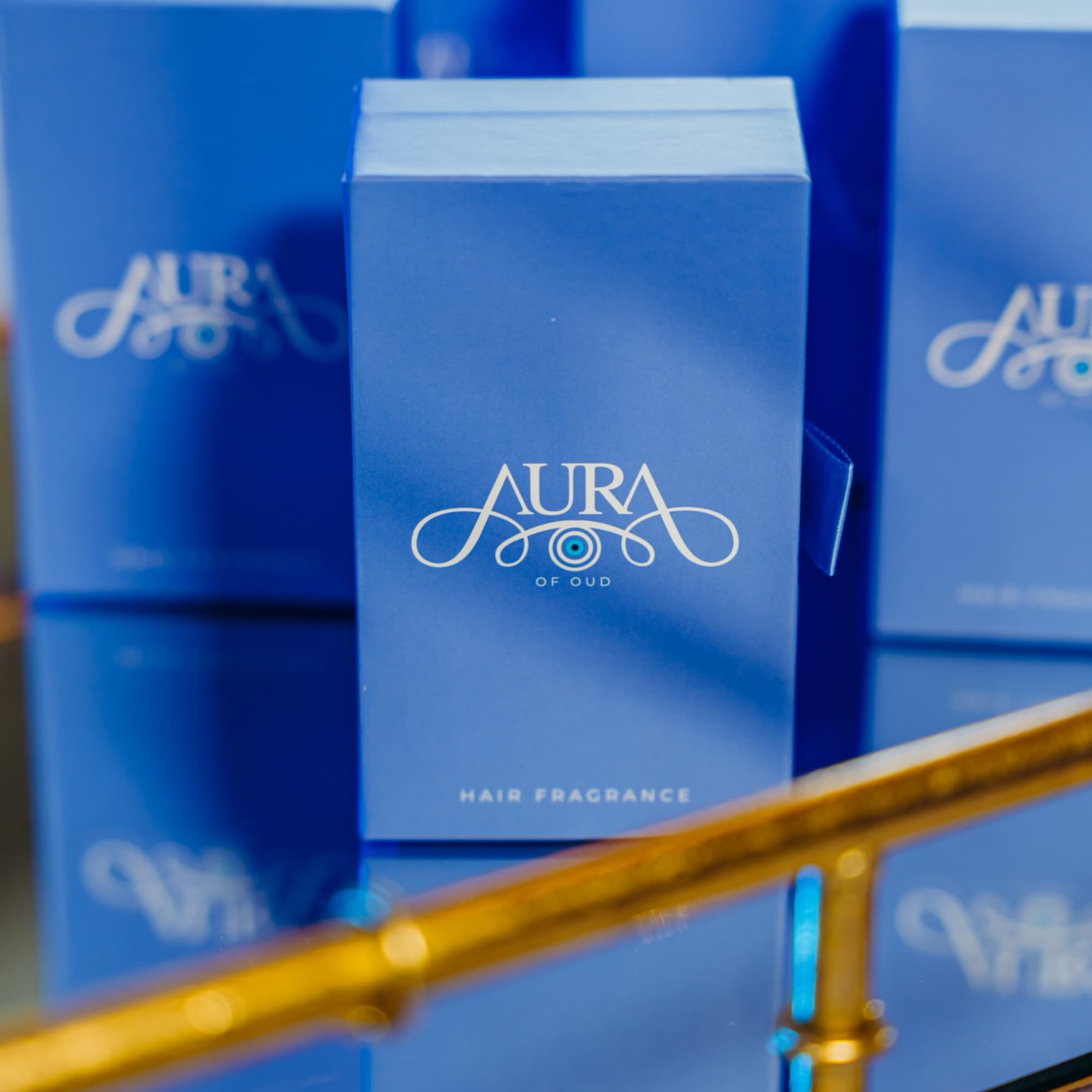 Blue Aura of Oud hair fragrance boxes stacked together