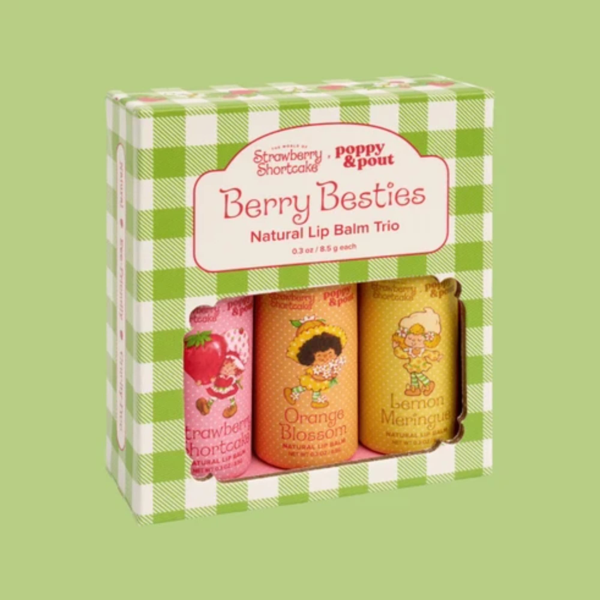 Boxed trio of berry-themed lip balms in pink, orange, and yellow packaging