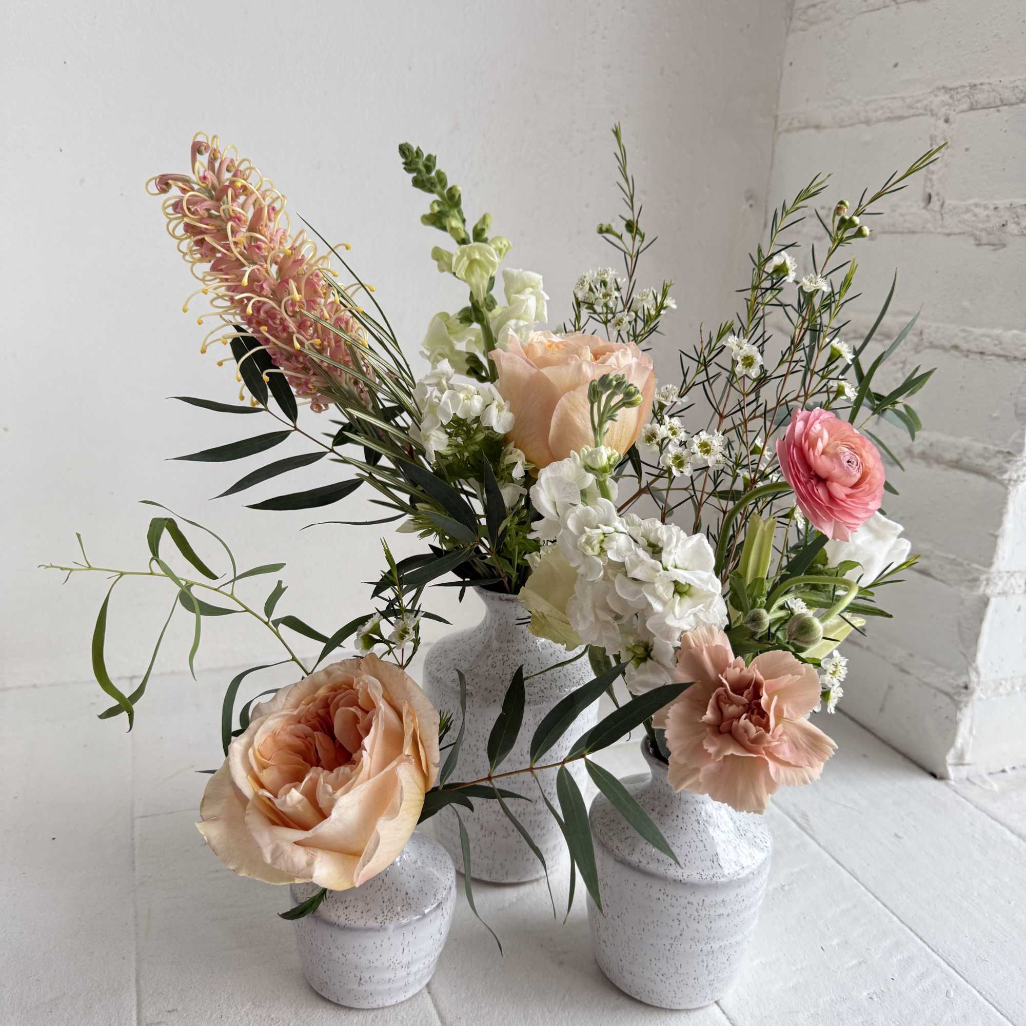 An eclectic mix of mostly peach flowers, with some white flowers in, photo 2 of 2