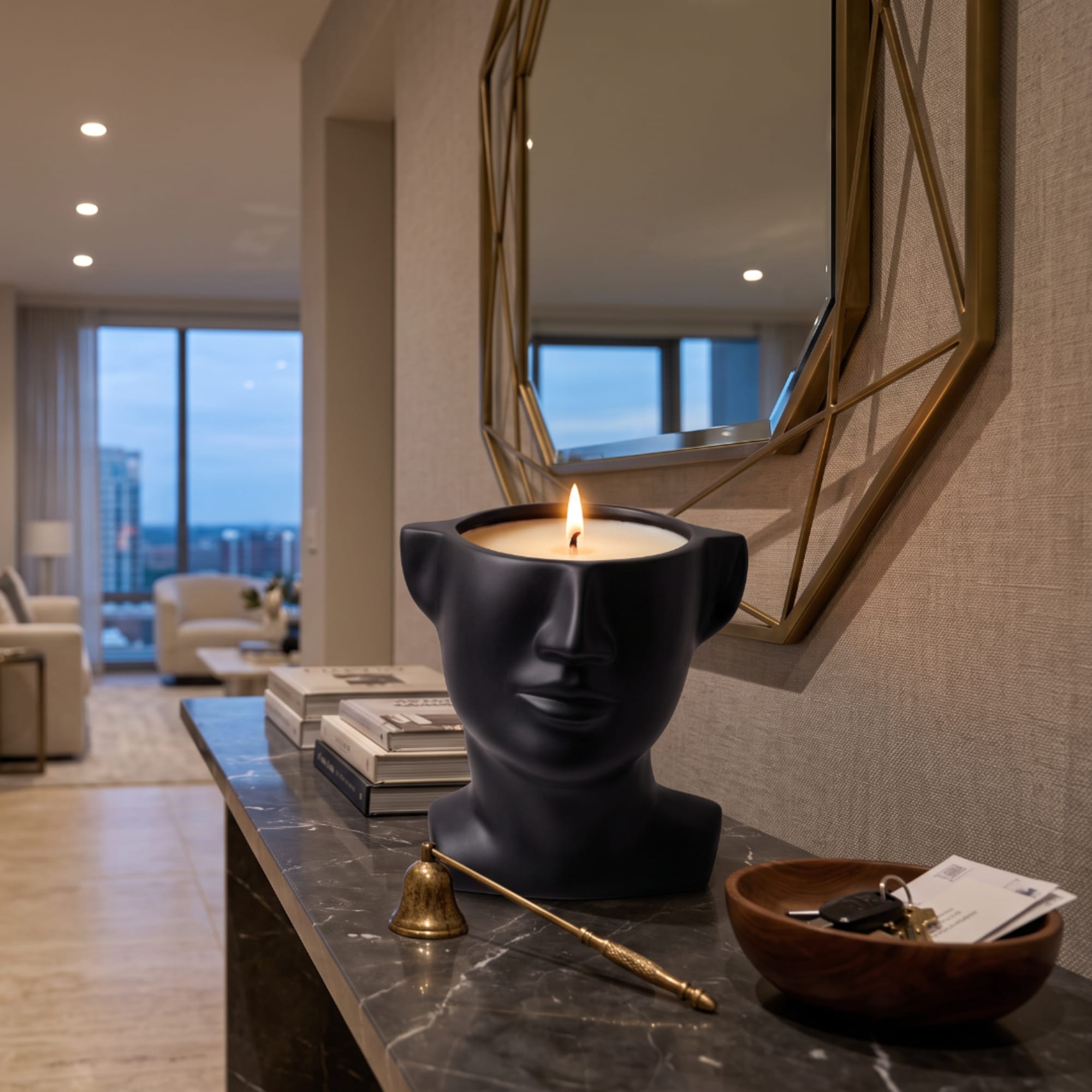 Black face-shaped candle on a console table with a lit flame