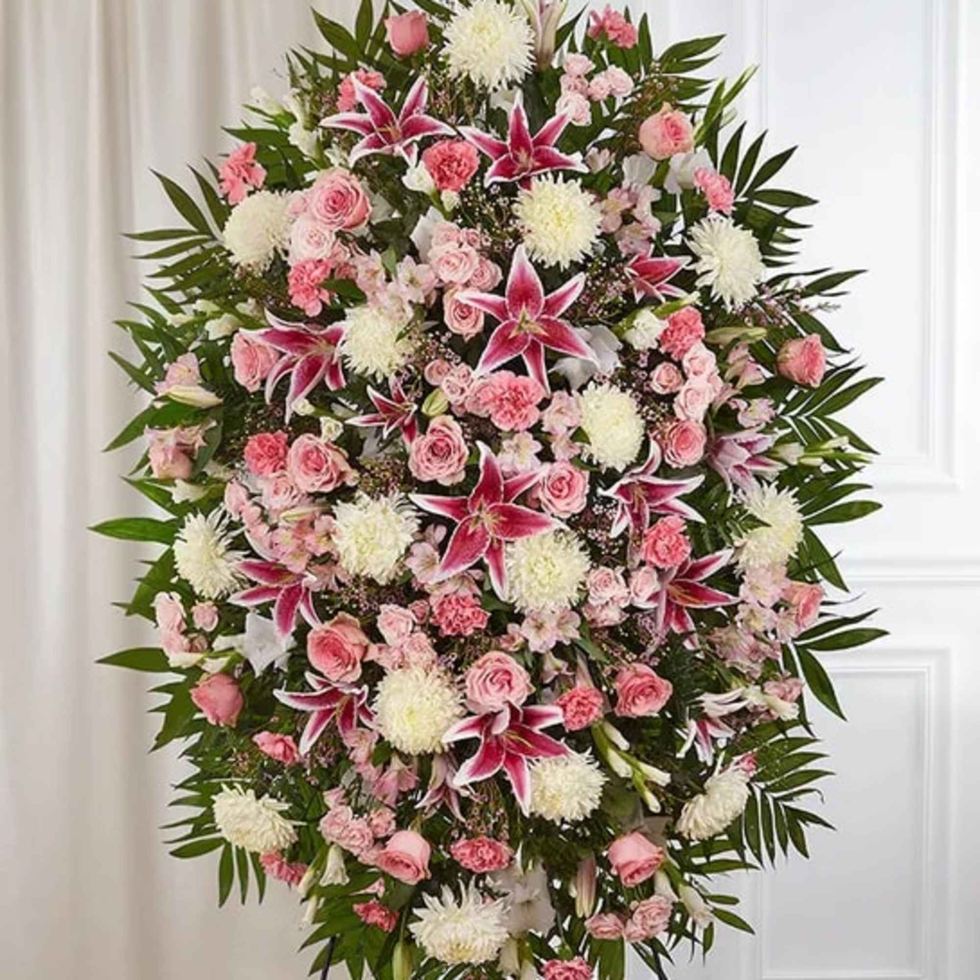 Large standing spray of pink and white flowers with lilies and roses