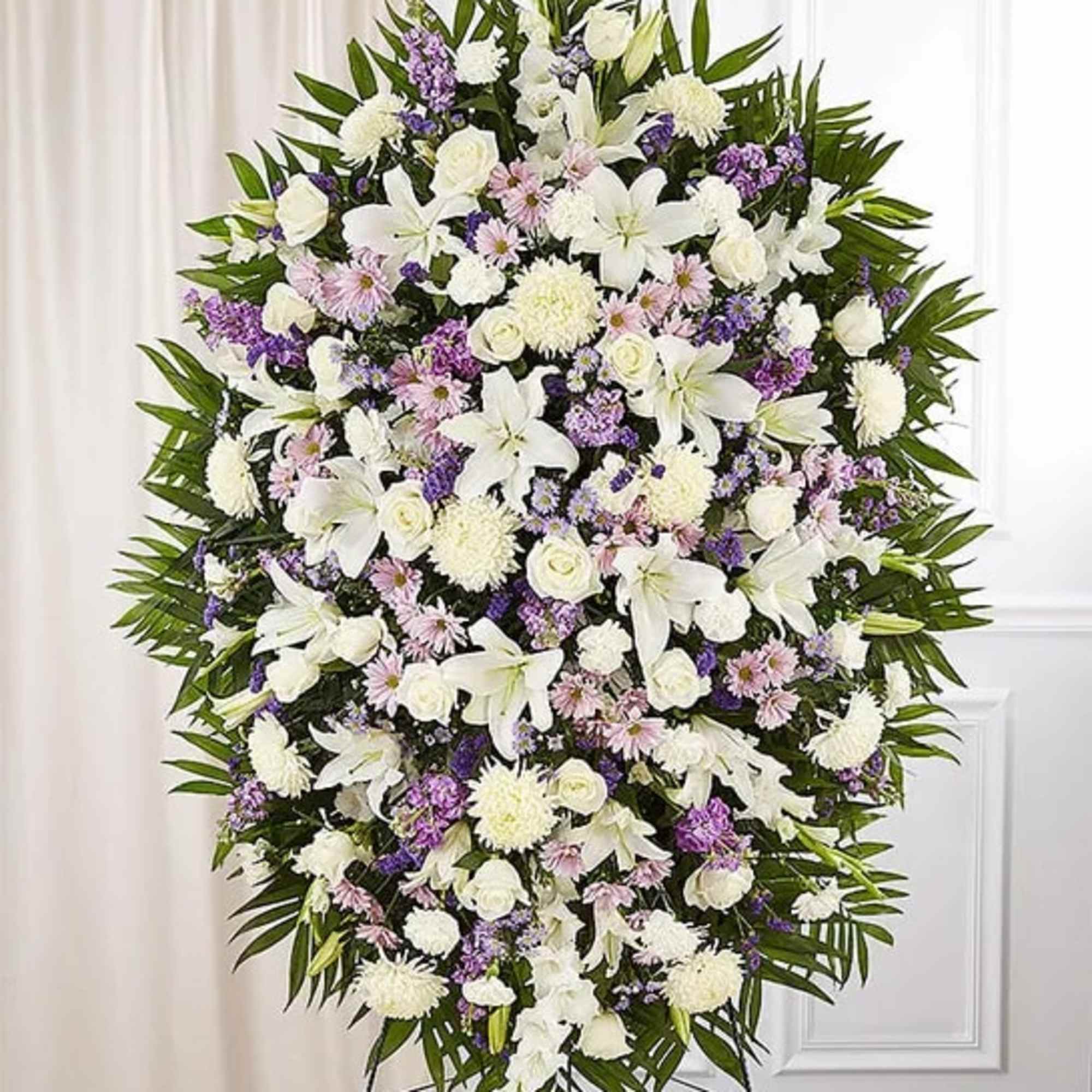 Large standing spray of white and purple flowers on a frame